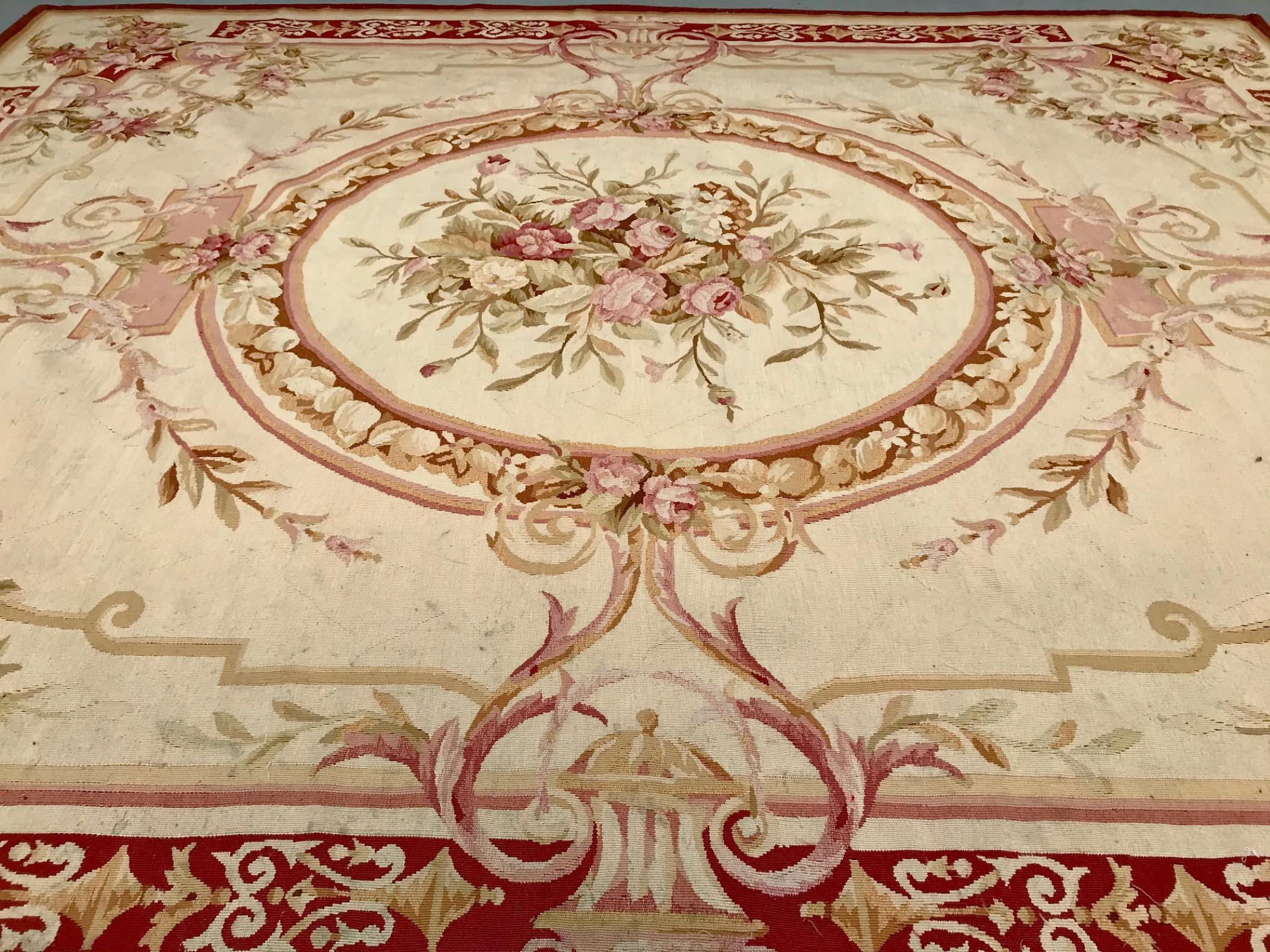 French Aubusson rug, 19th century Napoleon III

Characteristic French Aubusson rug of the late Baroque style. Distinguished by an ivory background, a floral medallion, defined by sinuous Rococo scrolls with elegant ornamentation of flowers, floats