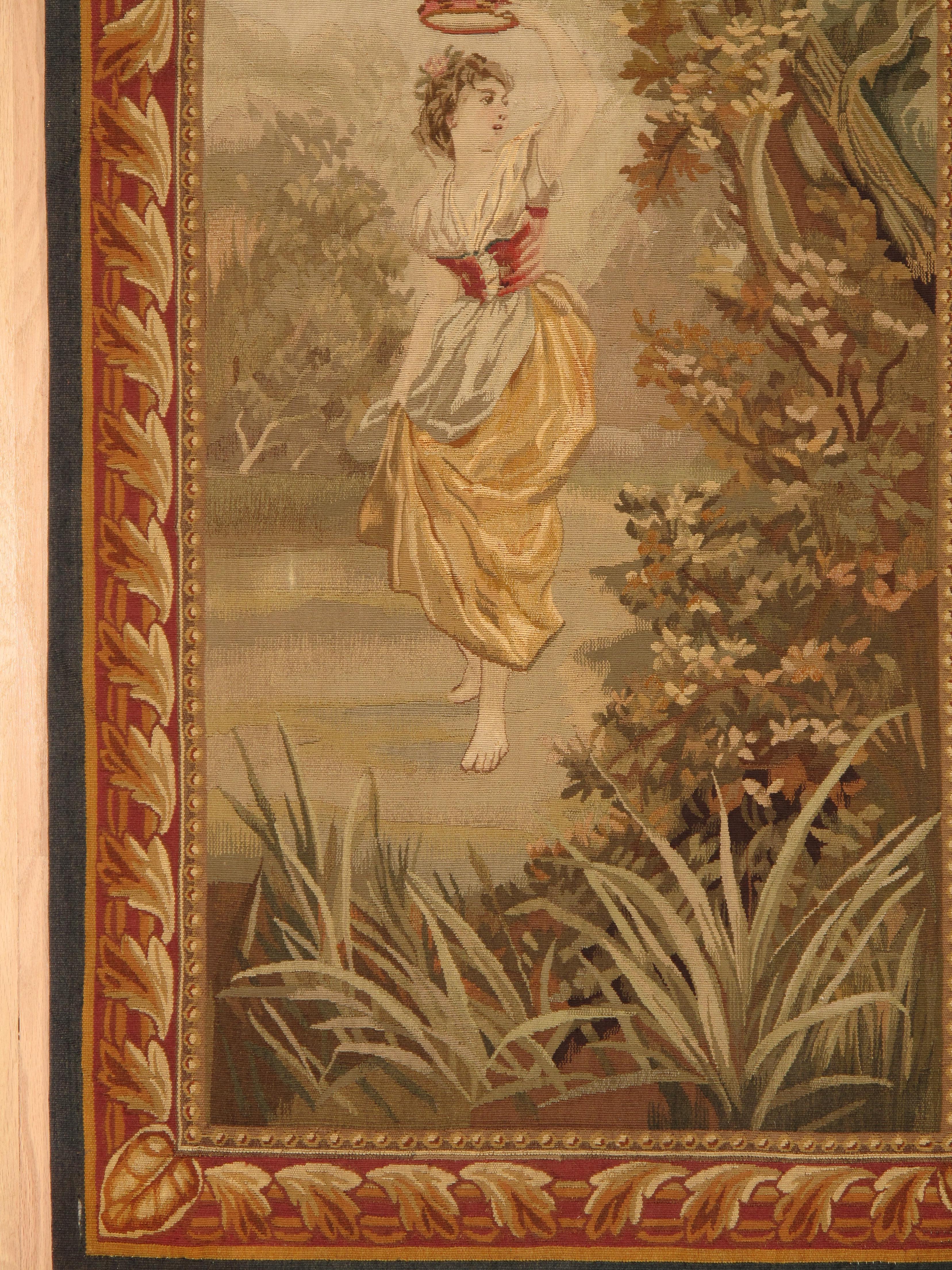 This 19th-century Aubusson tapestry depicting a young lady walking and dancing through the forest while playing the tambourine is a captivating masterpiece that captures the essence of elegance, grace, and joie de vivre. Created in 1885 and signed