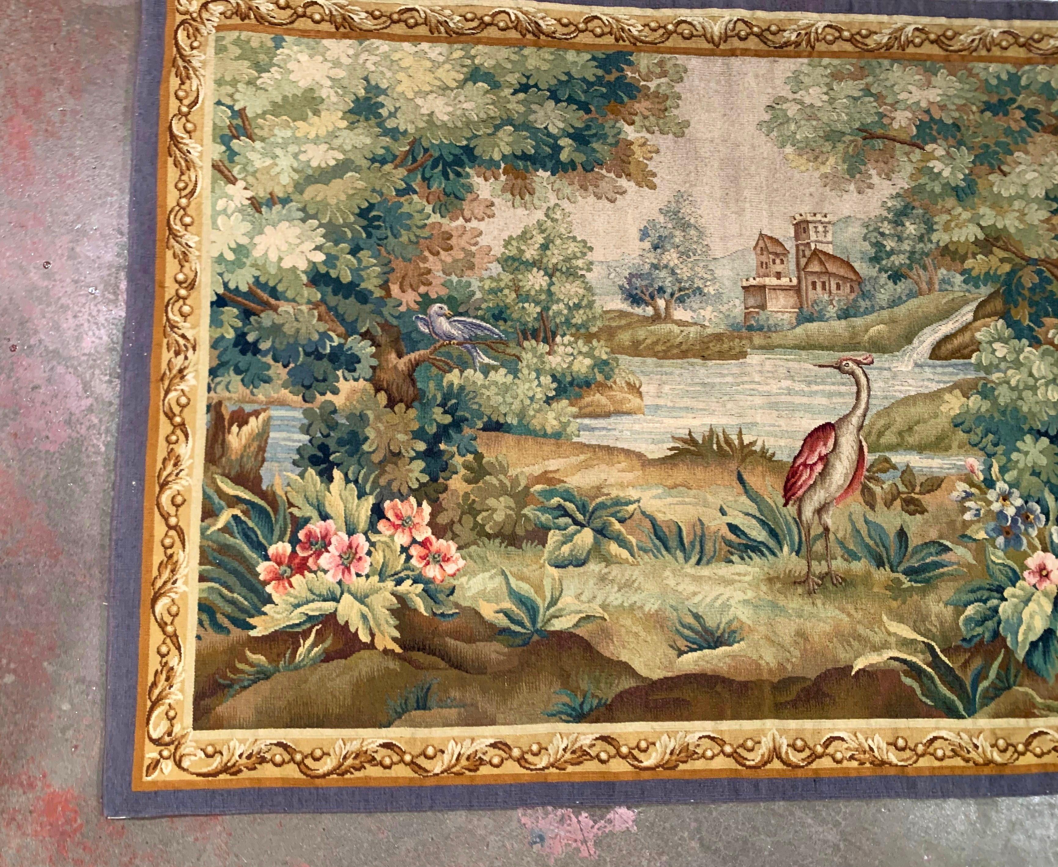 Place this antique tapestry over a buffet or in a staircase for a pop of color. Handwoven in Aubusson, France, circa 1870, the colorful, rectangular wall piece has its original floral and cherry border. The composition decorated with foliage and