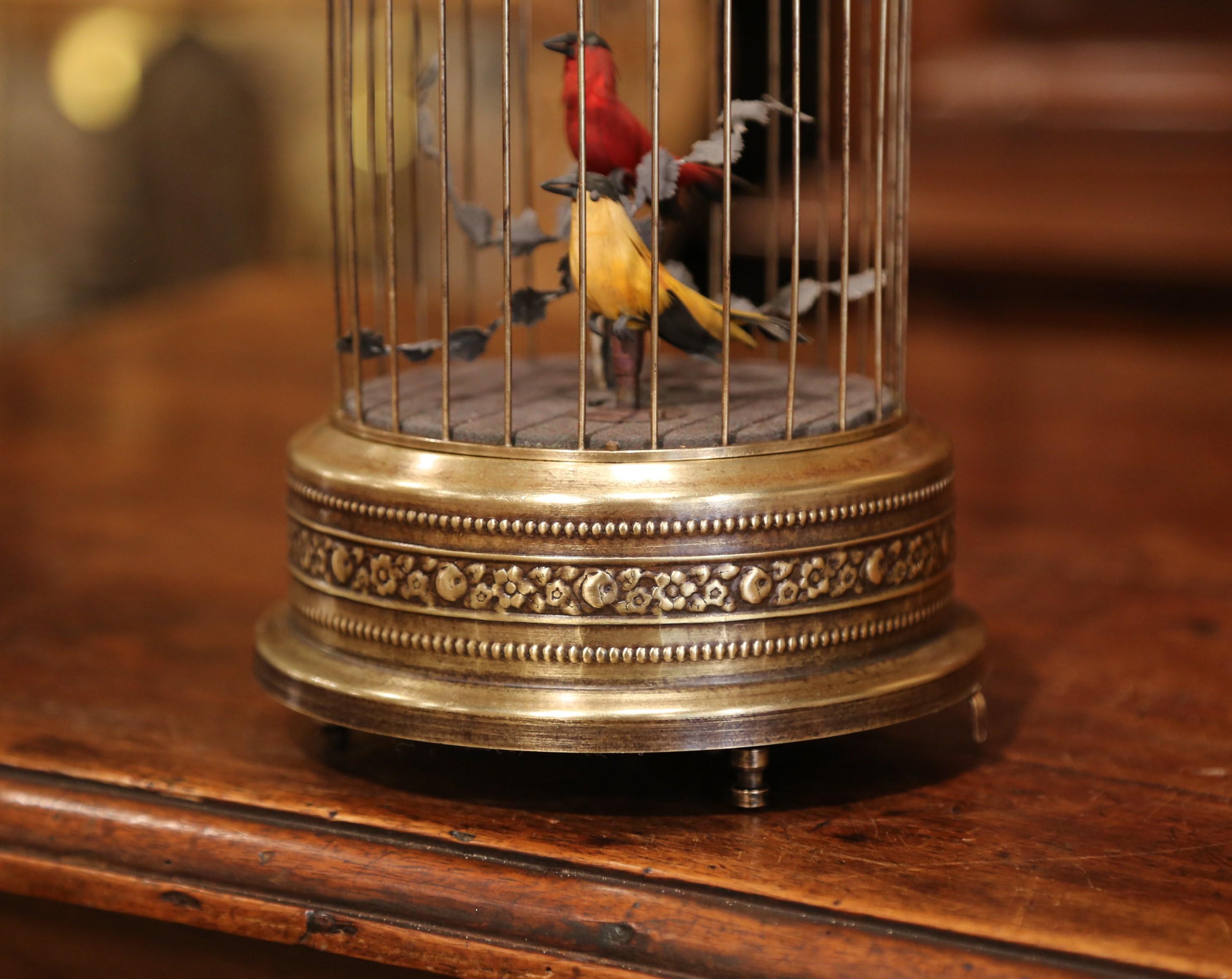 Add a charming, lively detail to a mantel (fireplace) or tabletop with this colorful, antique birdcage. Crafted in France circa 1880, the Classic cage is cylindrical in shape and is topped with a rounded dome. Inside the gilded cage, there are two