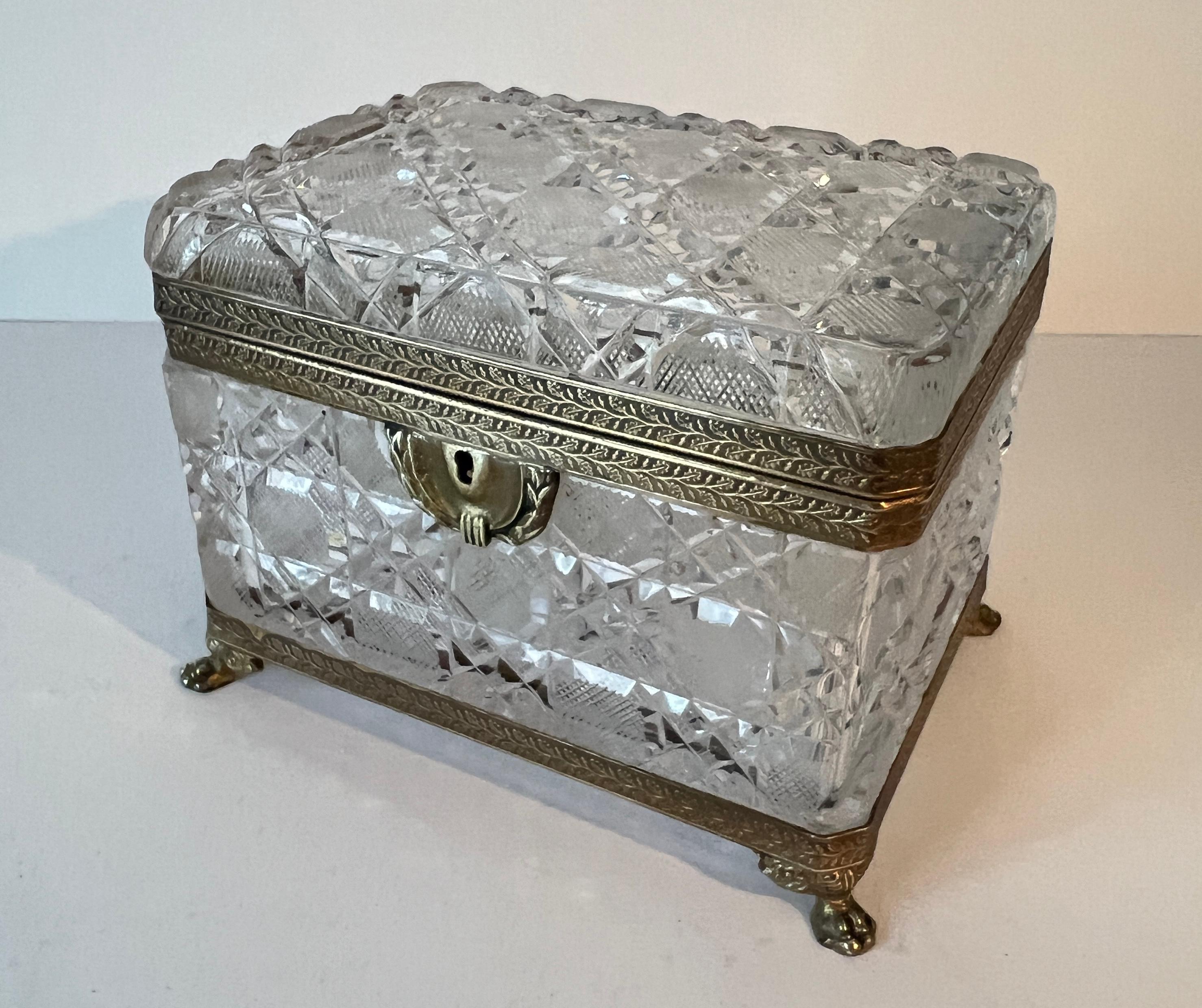 Un Impresionante y Grande Cofre / Caja de joyas de Baccarat de Cristal Tallado Francés con Bisagra de Bronce Dorado, cierre y Soporte de Patas.

El Cristal tallado confiere a la caja un conjunto de luces de rebote multifacéticas.  Un complemento