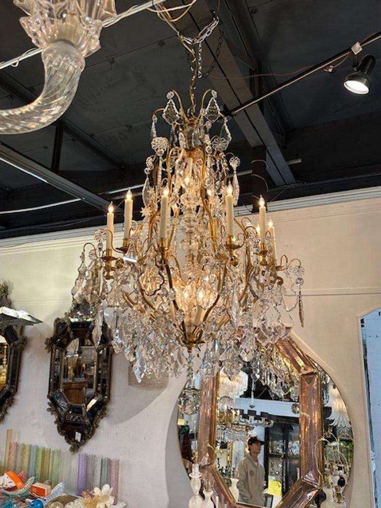 Outstanding 19th century French Baccarat manner crystal and gilt bronze chandelier. Featuring a plethora of glistening crystals on a curve base. A true work of art! Stunning!!