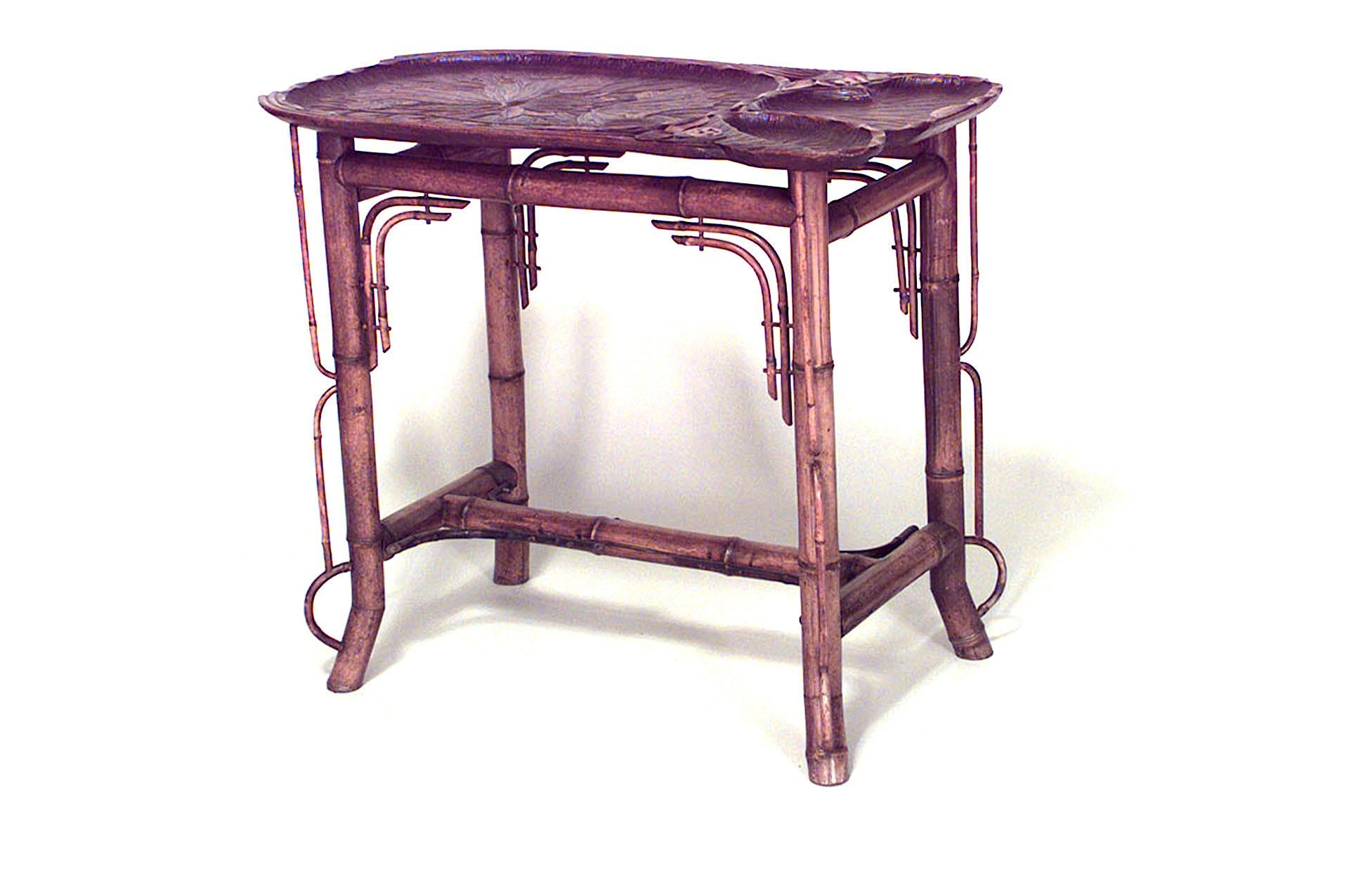 Bamboo French Victorian end table with carved lily pad top and stretcher.
