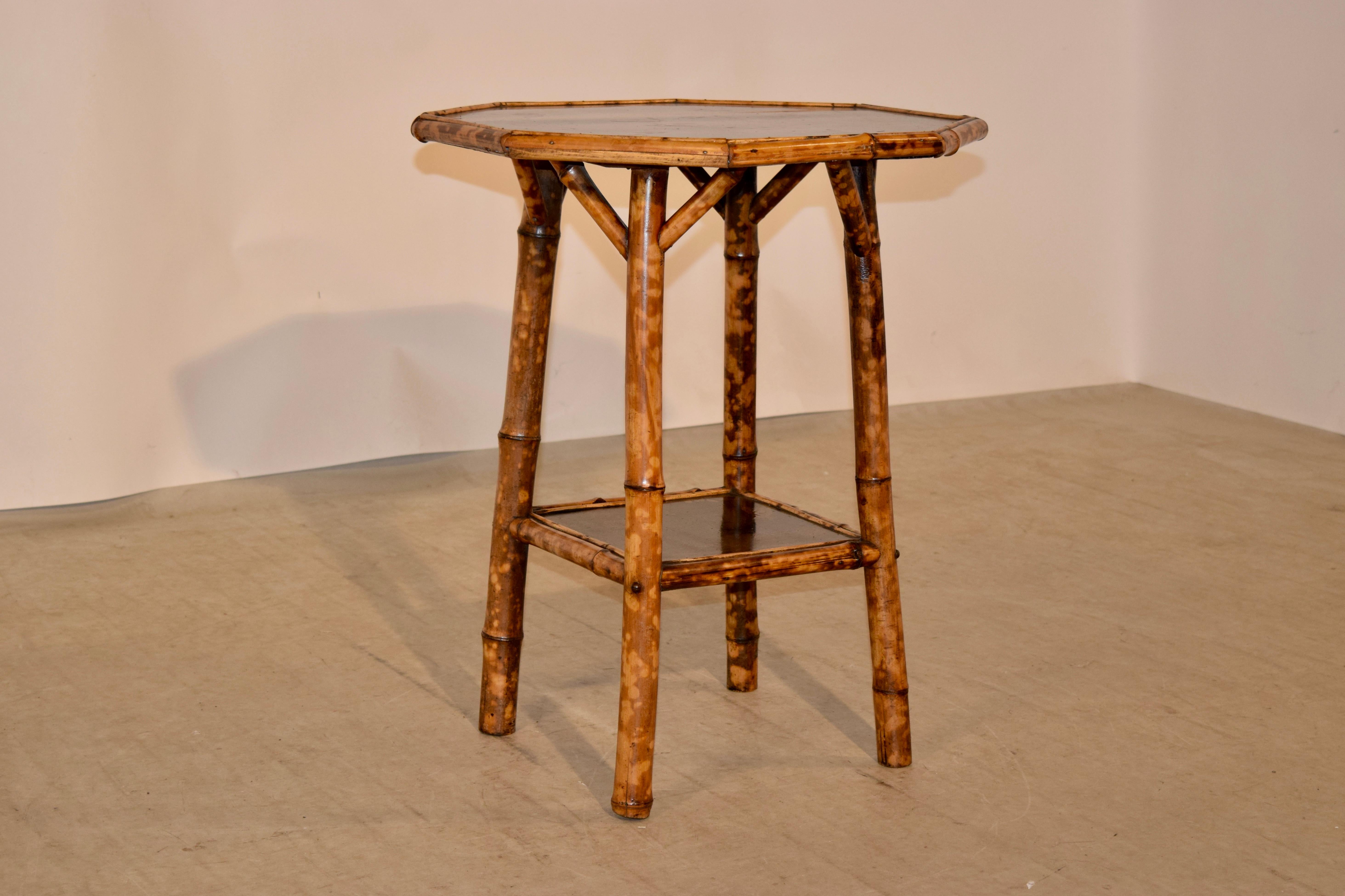 19th century tortoise bamboo table from France with a chinoiserie painted top and lower shelf. Normal wear and slight losses to chinoiserie from age and use.