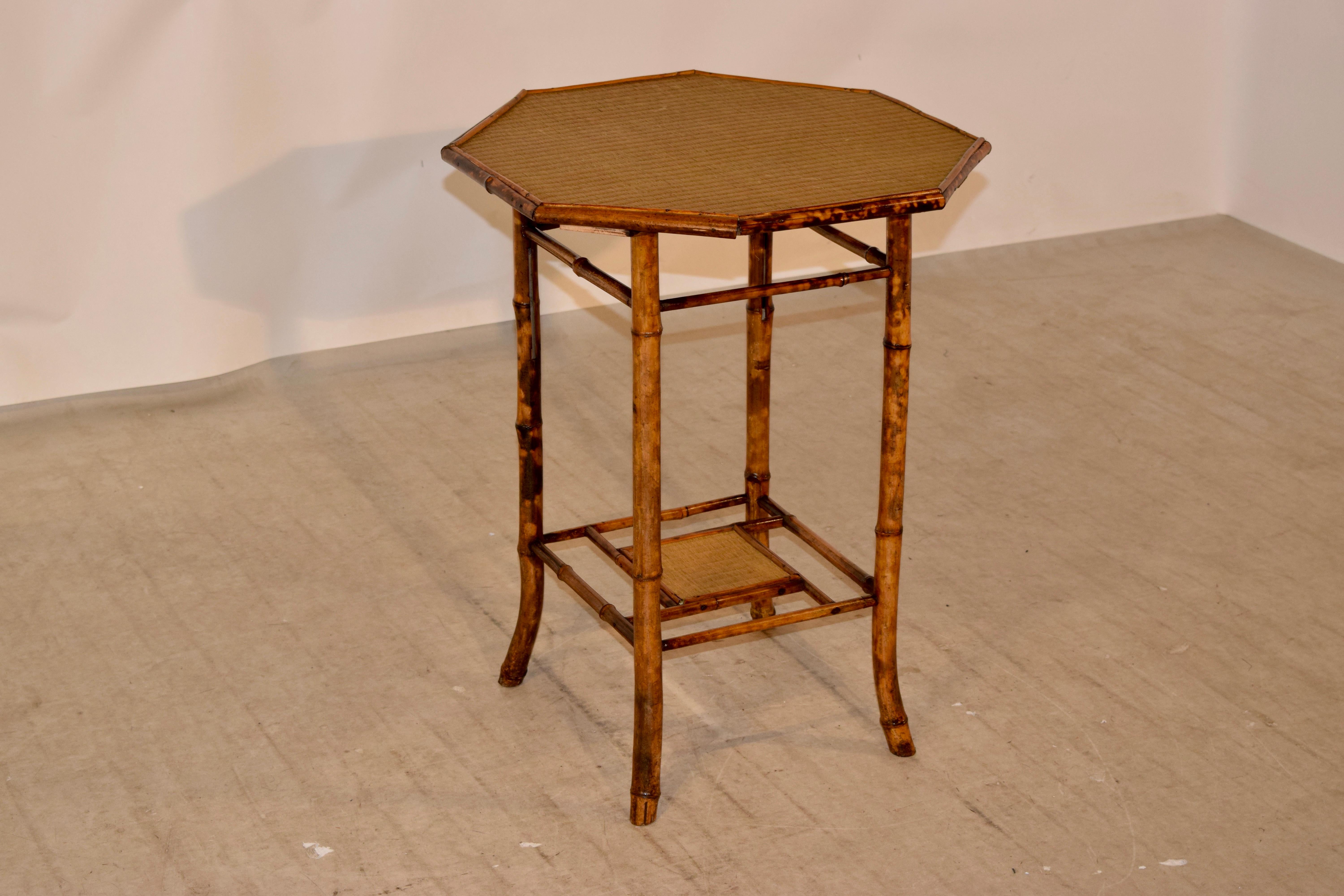 19th century French tortoise bamboo table with rush covered top and lower shelf. Lovely splayed legs.