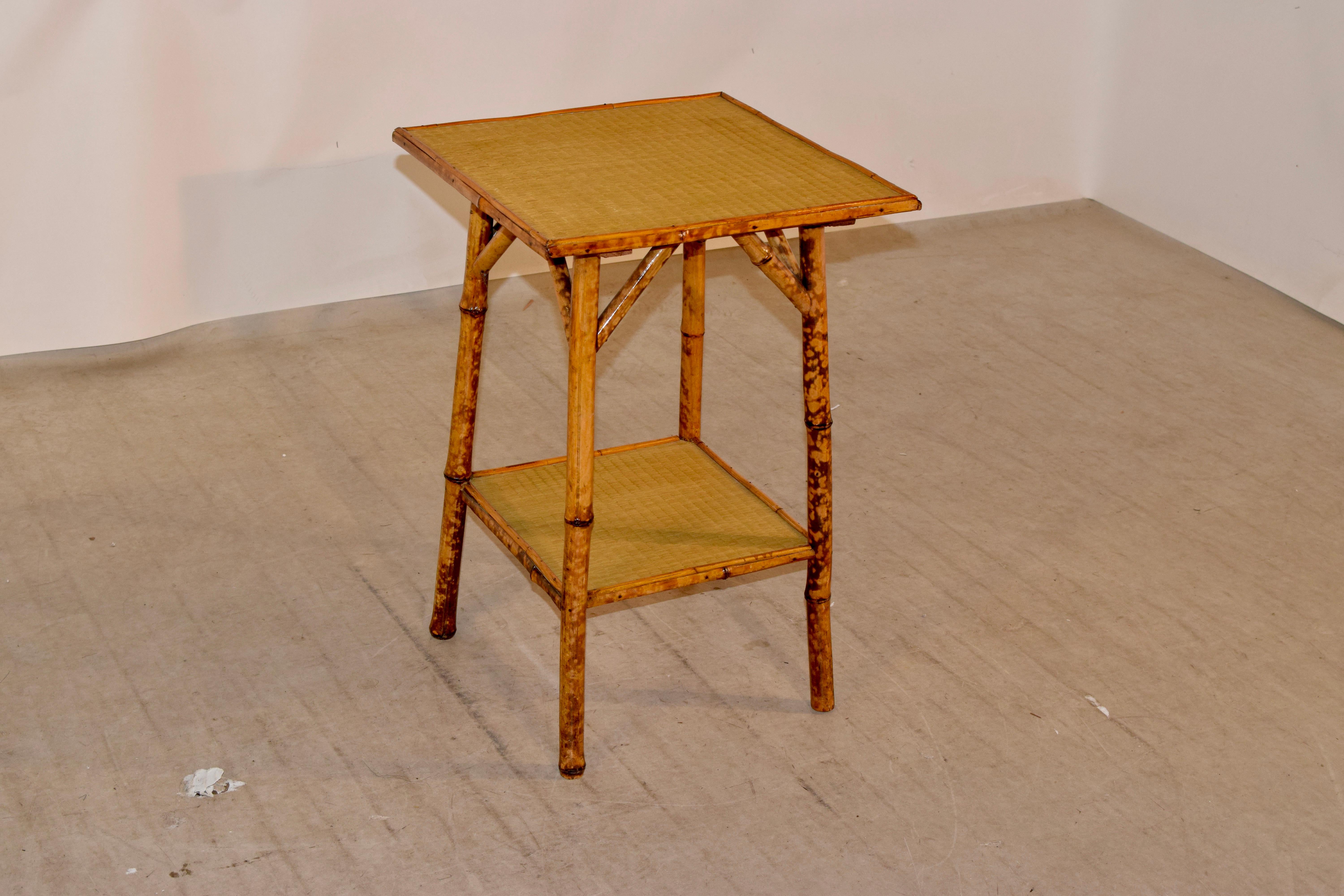 19th century tortoise bamboo table from France with a rush covered top and lower shelf.