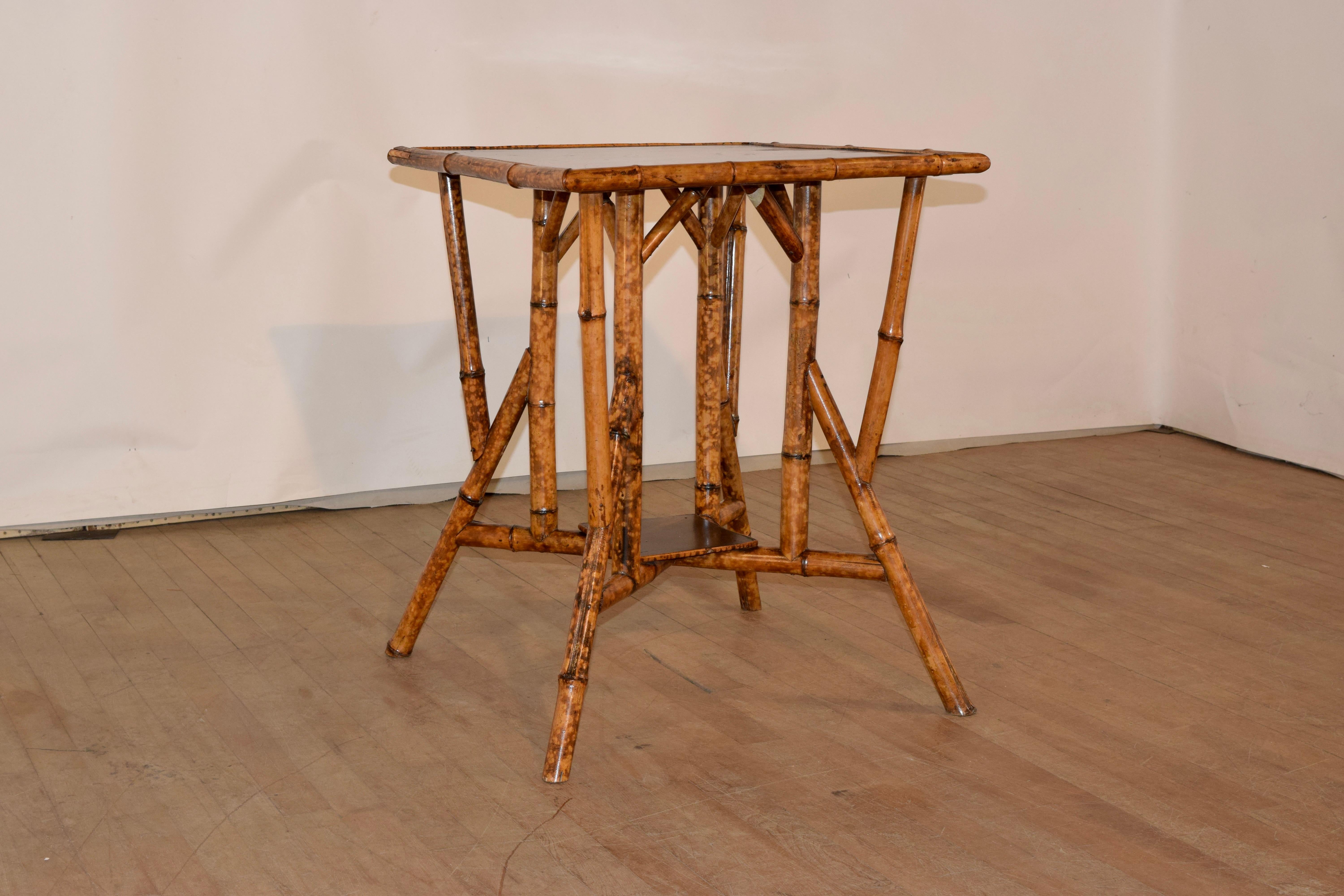 19th Century tortoise bamboo side table from France with a hand painted chinoiserie top and lower shelf. The frame is very interesting and unusual. It is made from tortoise bamboo and has splayed legs, joined by stretchers. This is a wonderful