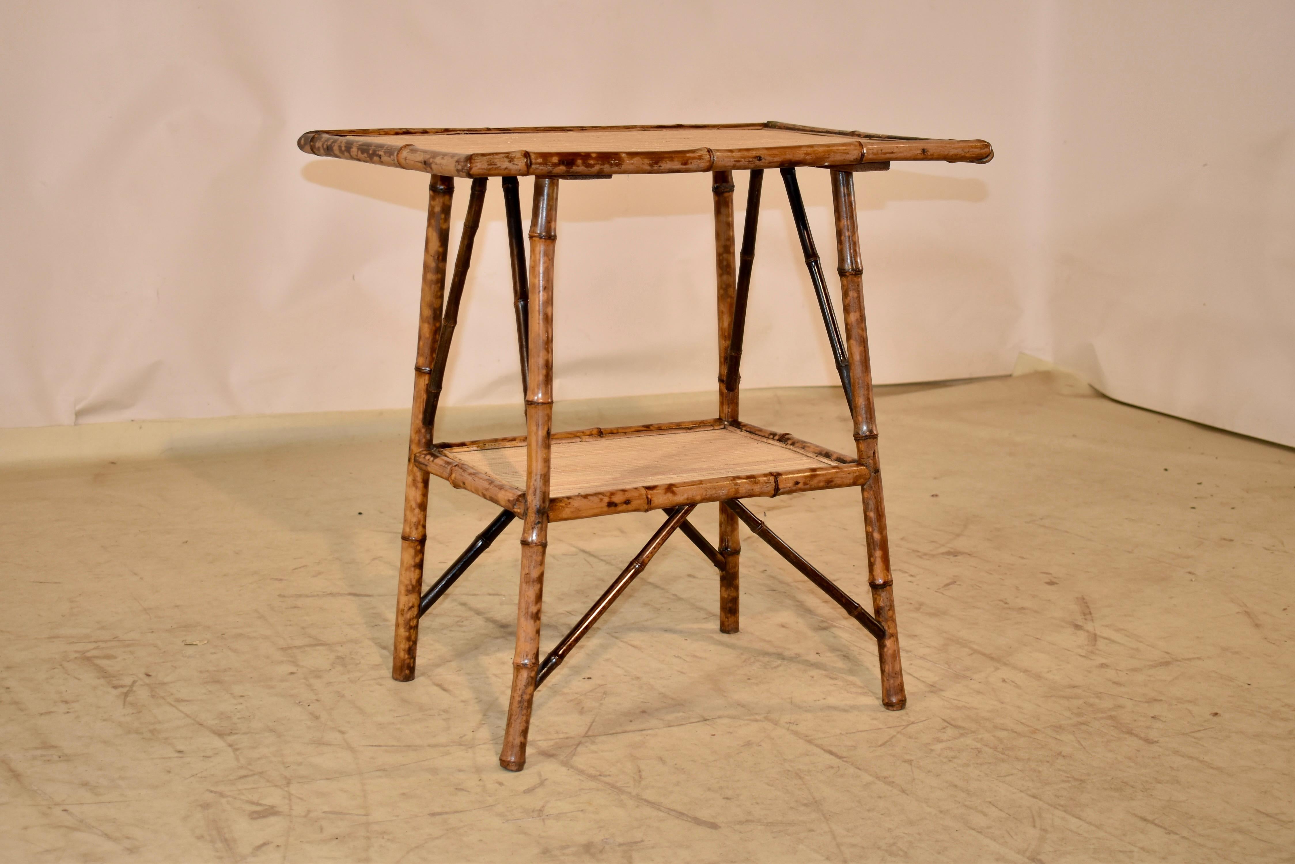 19th century tortoise bamboo side table from France.  The top is covered in seagrass and is supported on splayed legs.  The legs are joined by a lower shelf, which is also covered in seagrass.  This is a wonderful table with gorgeous patina that