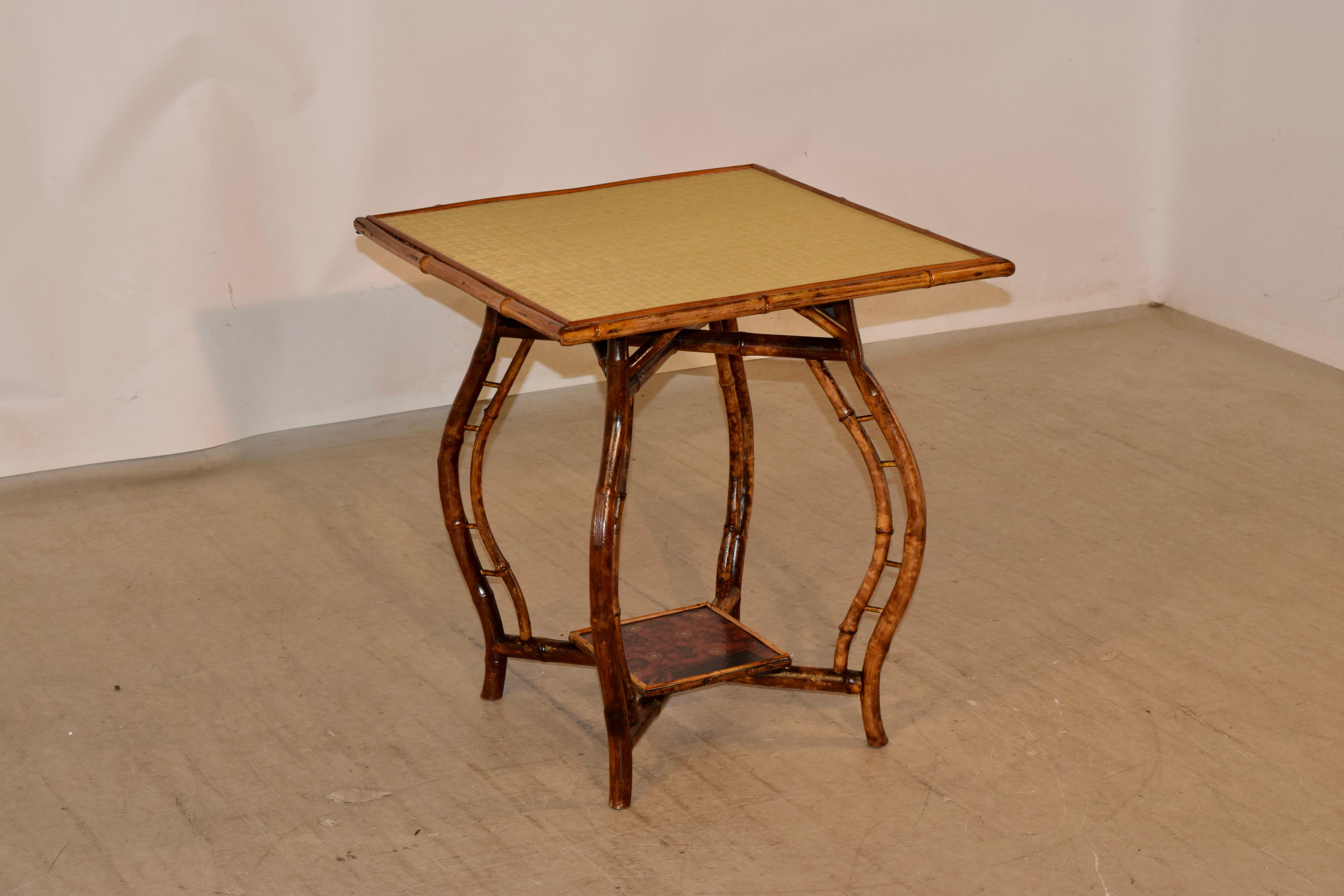 19th century French bamboo table with wonderful Art Nouveau period style. The top has been restored with new rush, and is supported on top of a wonderful frame with exceptional double cabriole legs, joined at the bottom by stretchers and a small