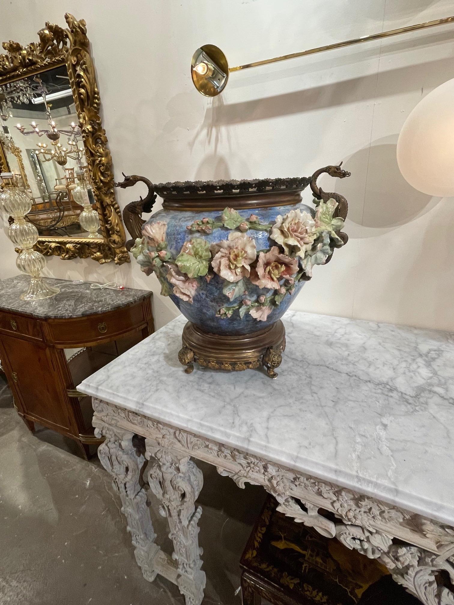 Exceptional 19th century French large scale Barbotine Majolica Jardinere on bronze feet. Beautiful pink flowers on a blue vase. Also note the bronze handles that are in the shape of dragons. Very fine quality. So pretty and a true work of art!!