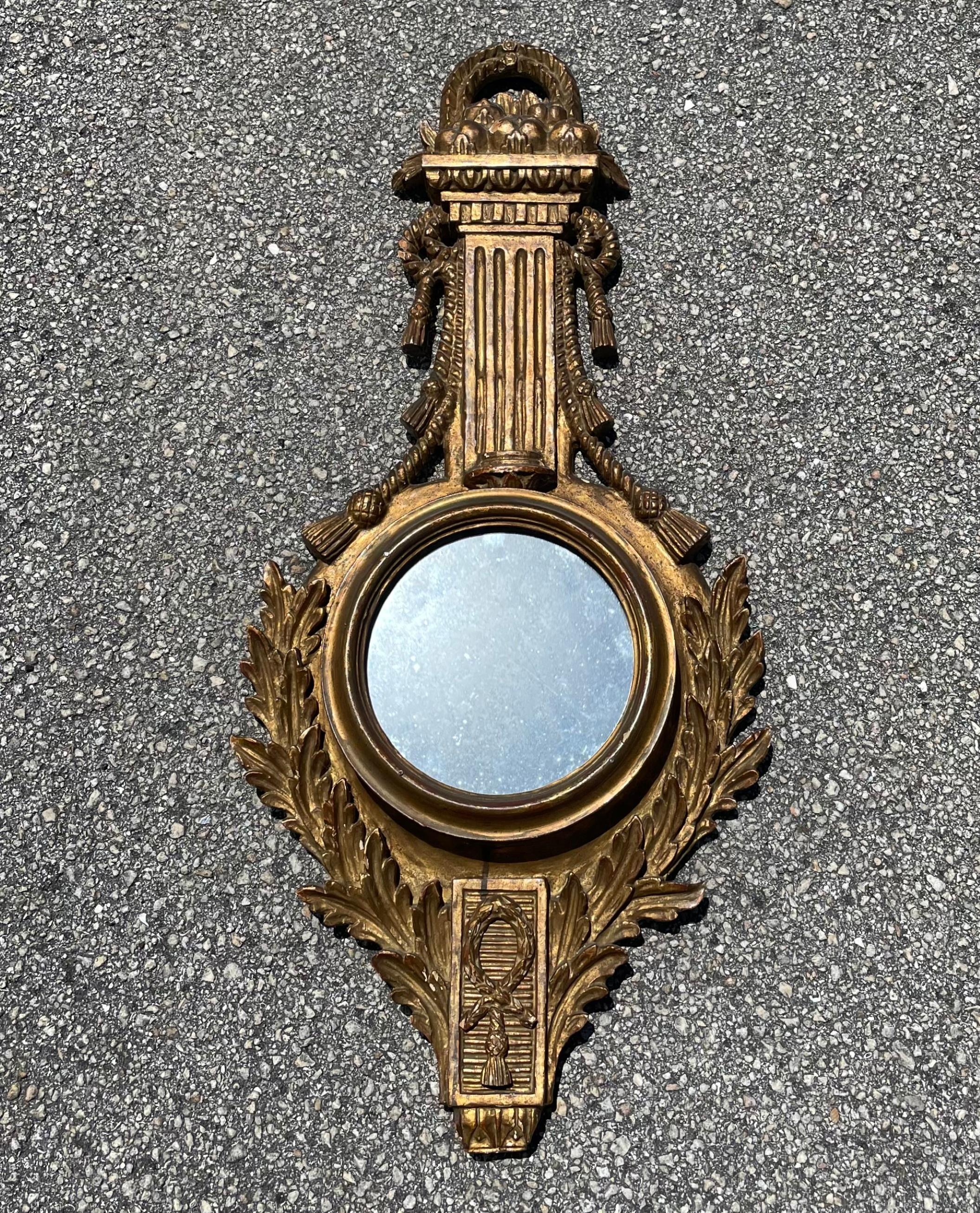 Highly decorative 19th century French Baroque style Barometer case mirror.

Repurposed barometer wall hanging case of the 19th century now houses a circular mirror. The glorious patinated giltwood Baroque style case is hand carved in Fine detail