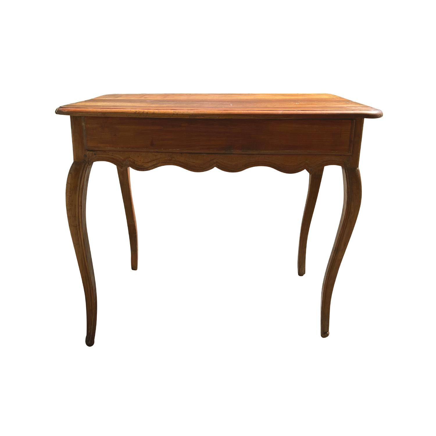 An early 19th Century Baroque style center, console table from Provence, in good condition. This antique Provencal table is hand crafted in solid Walnut. It is refinished with a rich and warm colored hand waxed patina. Beautifully shaped fine
