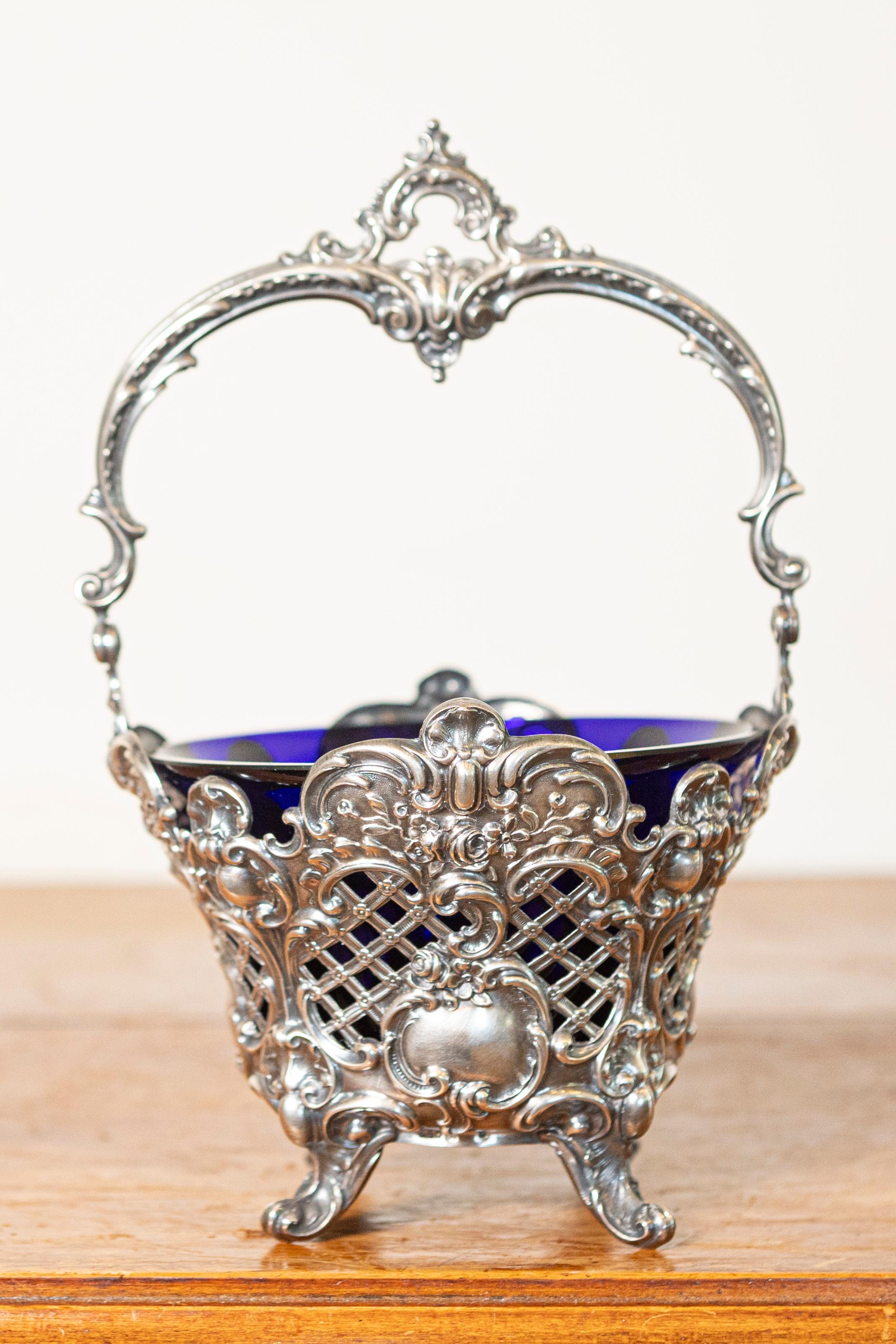 This exquisite 19th Century French basket is a testament to the opulence and intricate craftsmanship of the era. The finely detailed silver-plated openwork showcases scrolling motifs, floral embellishments, and an ornate handle, all of which reflect