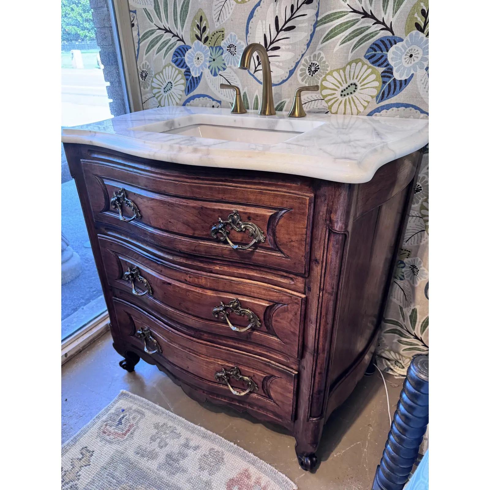 Ready to upstyle your bathroom space? This 19th century French commode feels fresh and functional again with addition of Turkish Carrera polished top and undermount sink. The marble top is off white with light grey veining, and has a lovely finished