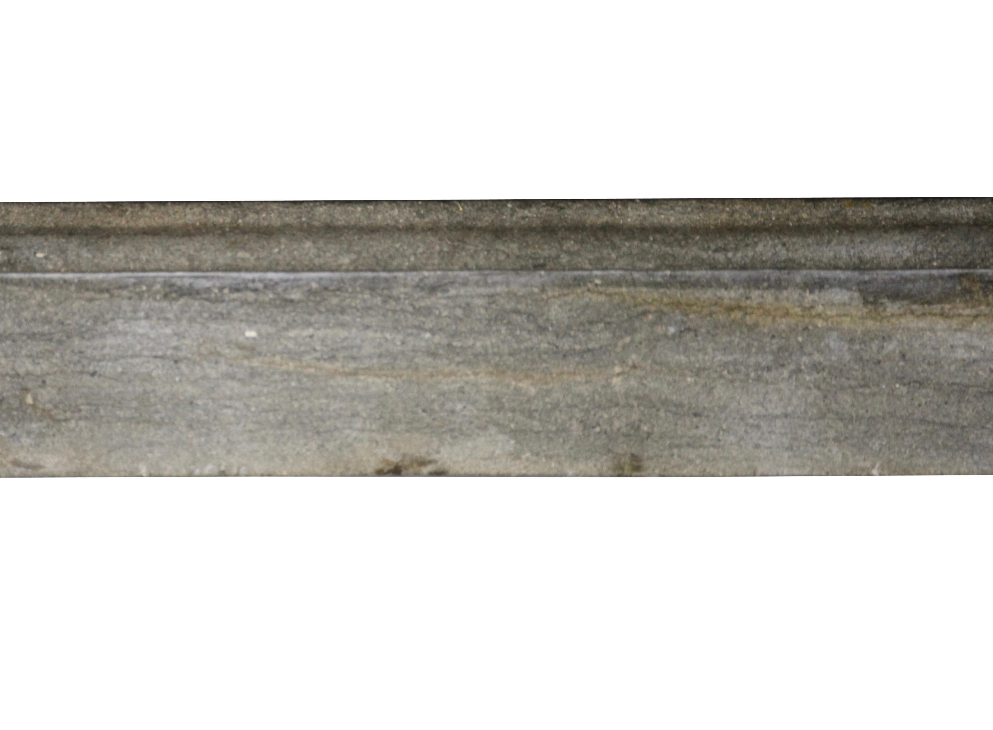 This original vintage fine European fireplace mantel with straight lines in a grey bicolor hard stone is a perfect fit for modern or contemporary interior design. The hard stone is a kind of a limestone
The waxed stone reflects the light in the