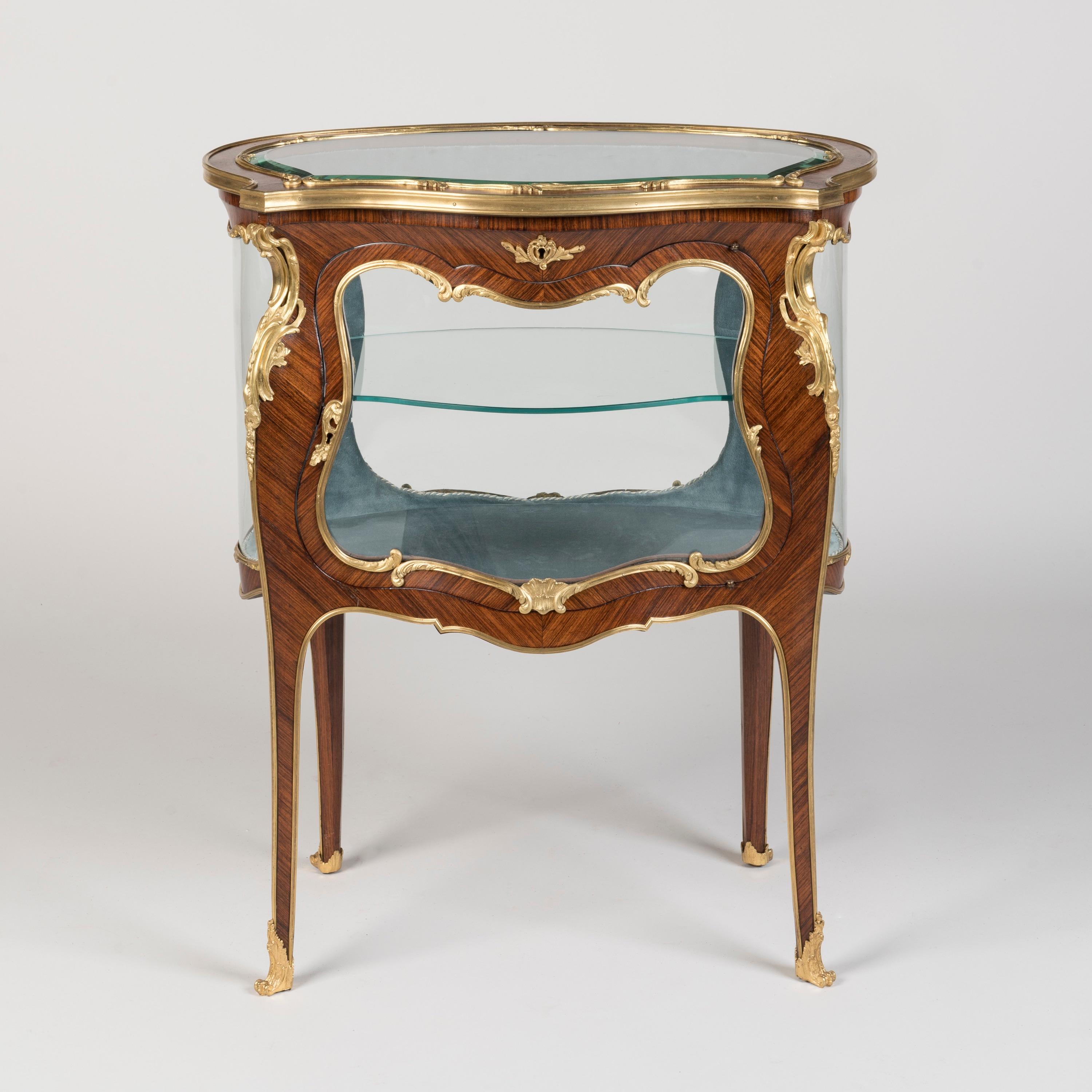 A French Bijouterie
In the manner of François Linke

Designed in the Louis XV style and constructed in a wonderfully marked Kingwood, with precise and crisply cast ormolu mounts; rising from sabot shod cabriole legs dressed with ormolu