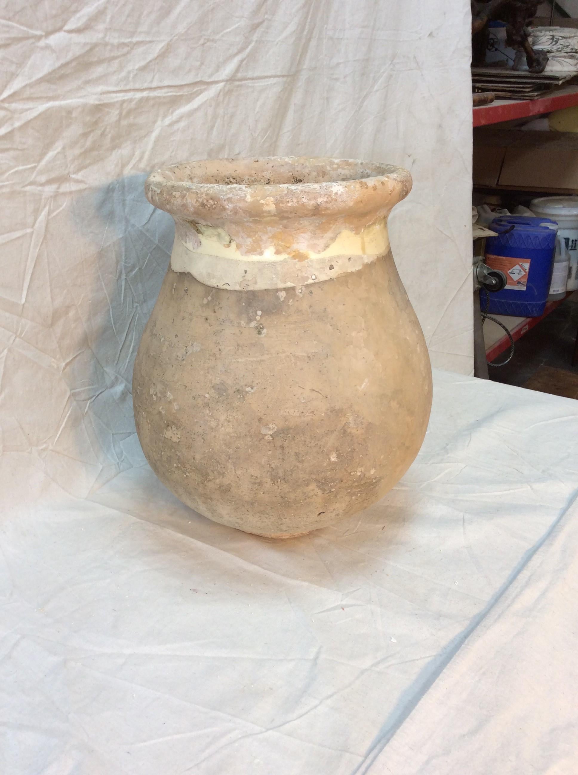 This is a beautiful French olive jar from the Provençal town of Biot, France and features a lovely aged patina and pale yellow-glazed rolled edge and interior. The Alpes- Maritimes region of France has been known as a pottery center from the 18th