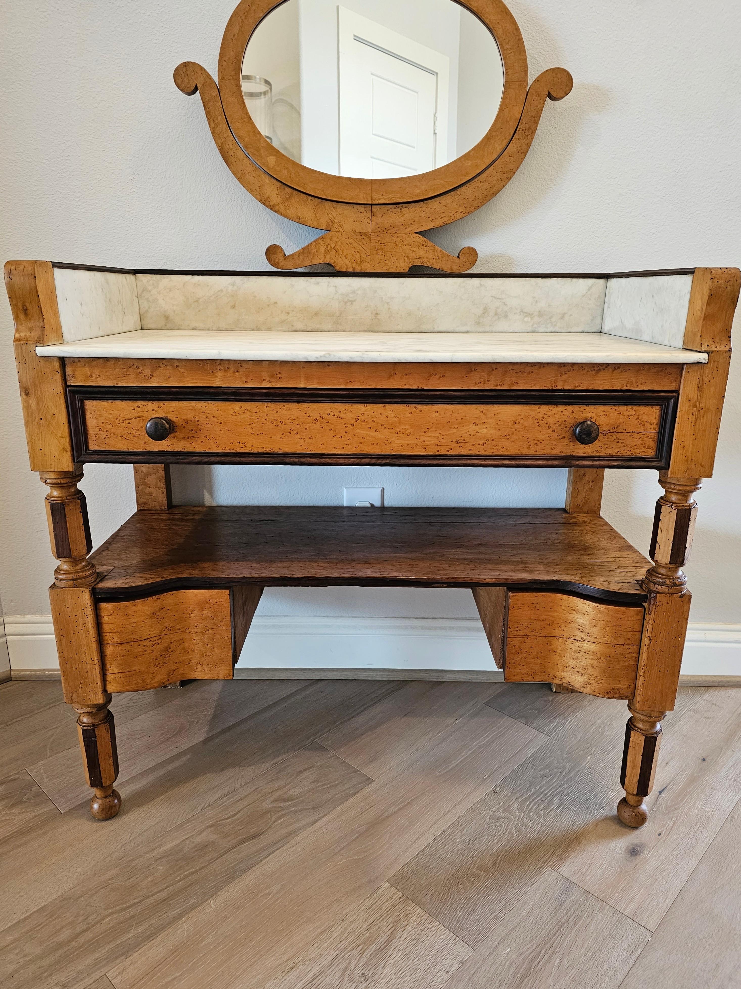 A lovely antique French birdseye maple wash stand. circa 1880

Finely hand-crafted in the second half of the 19th century, finished on all sides so it can be placed anywhere in the room, having a white and gray veined marble-lined top and partial