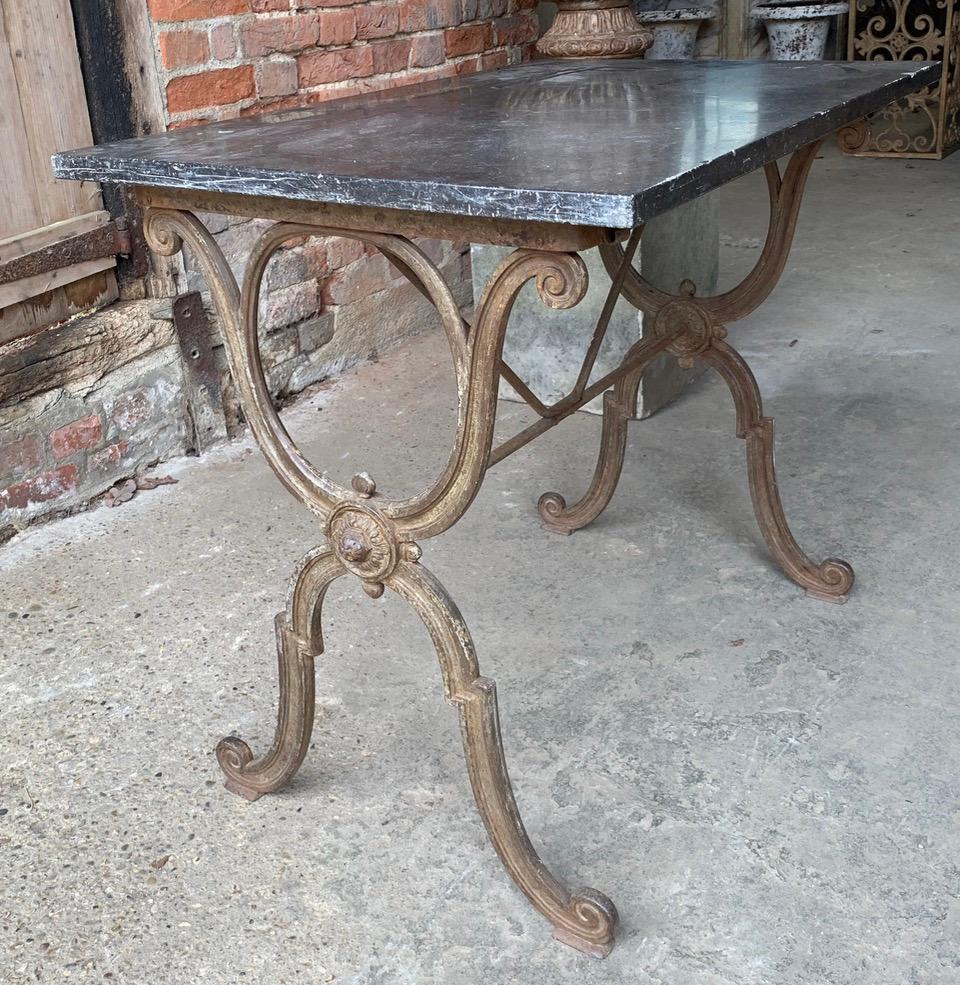 A nice 19th century French bistro table with an iron base which has a good patina. The black marble top has age related wear giving it a good look. 
This could be used indoors or in the garden.