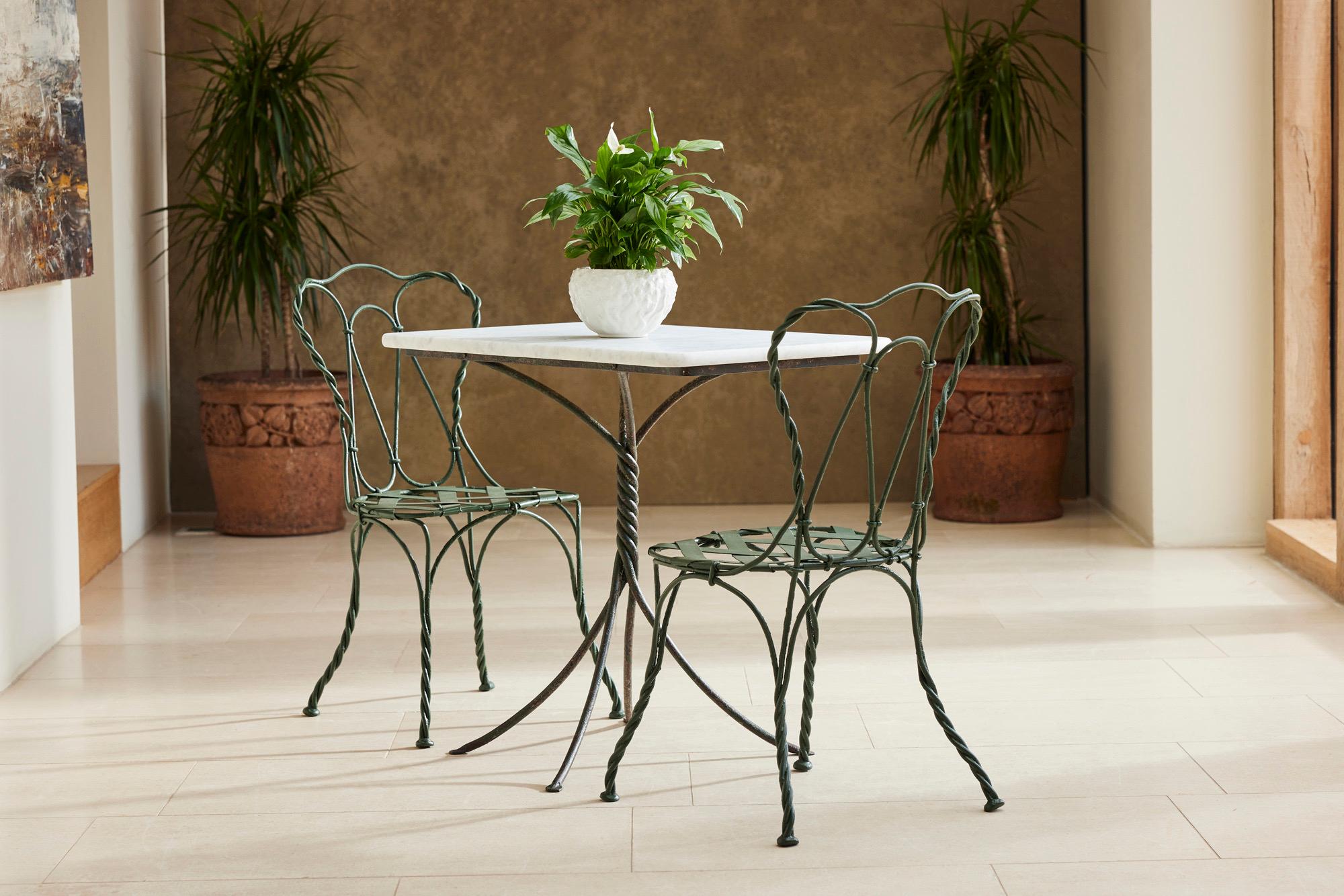 We found this lovely hand-forged bistro set in the South West of France.  The table and chairs were made from one piece of iron, twisted under heat to resemble rope. In very good condition considering age and use with its attractive marble top, this