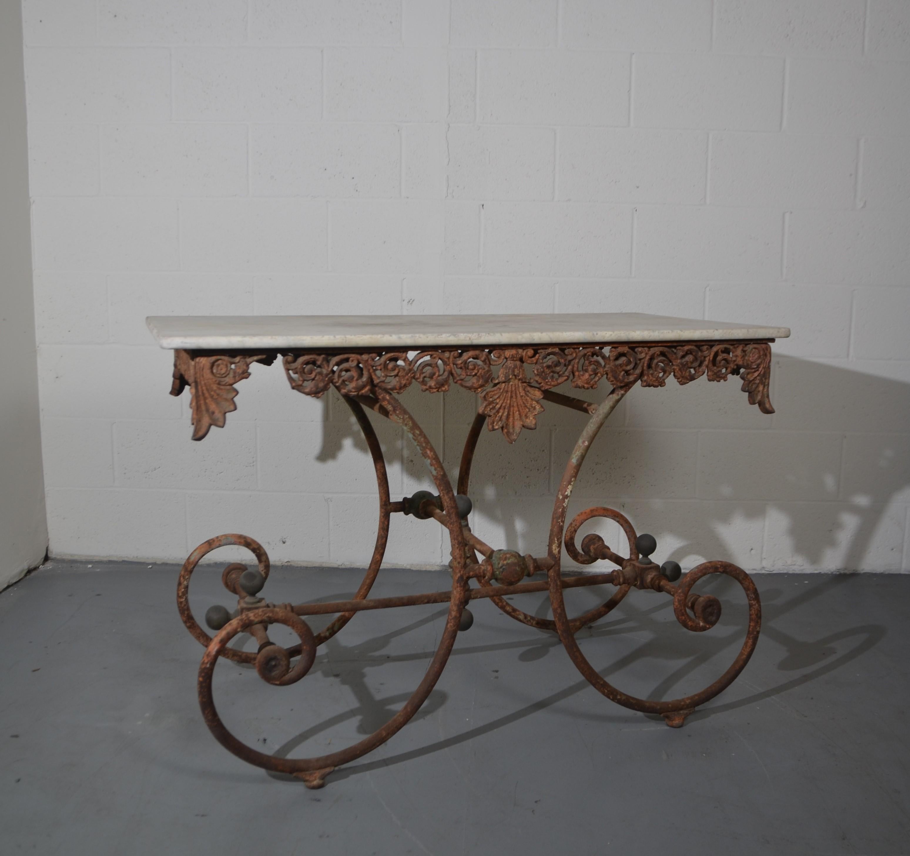 Rustic 19th-century French bistro table. The top is stone the base is iron.