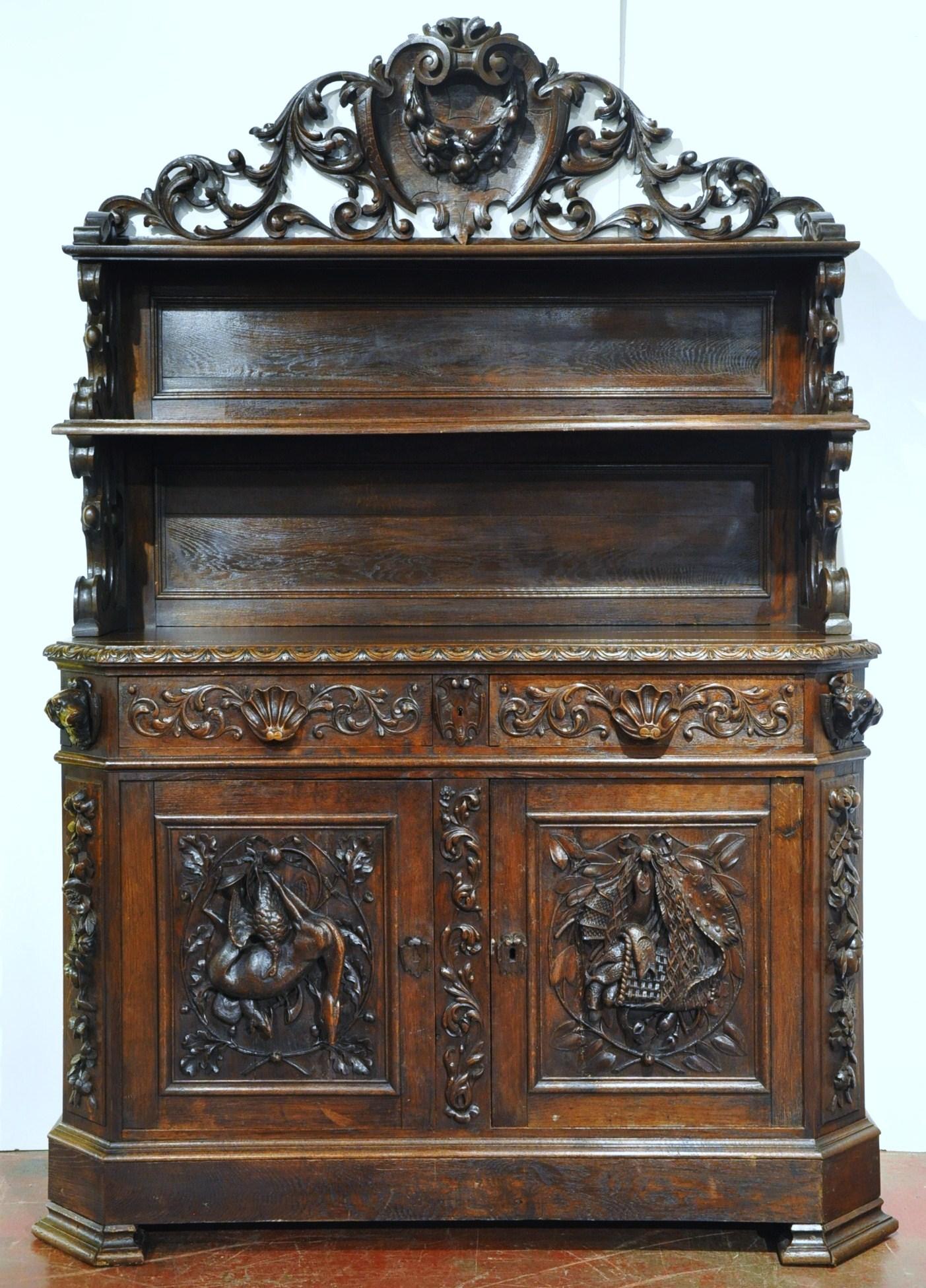 This elegant, three-piece antique display cabinet was crafted in France, circa 1870. The ornate buffet stands on square feet and features an ornate crown at the pediment decorated with a shell cartouche in the center with foliage on both sides. The