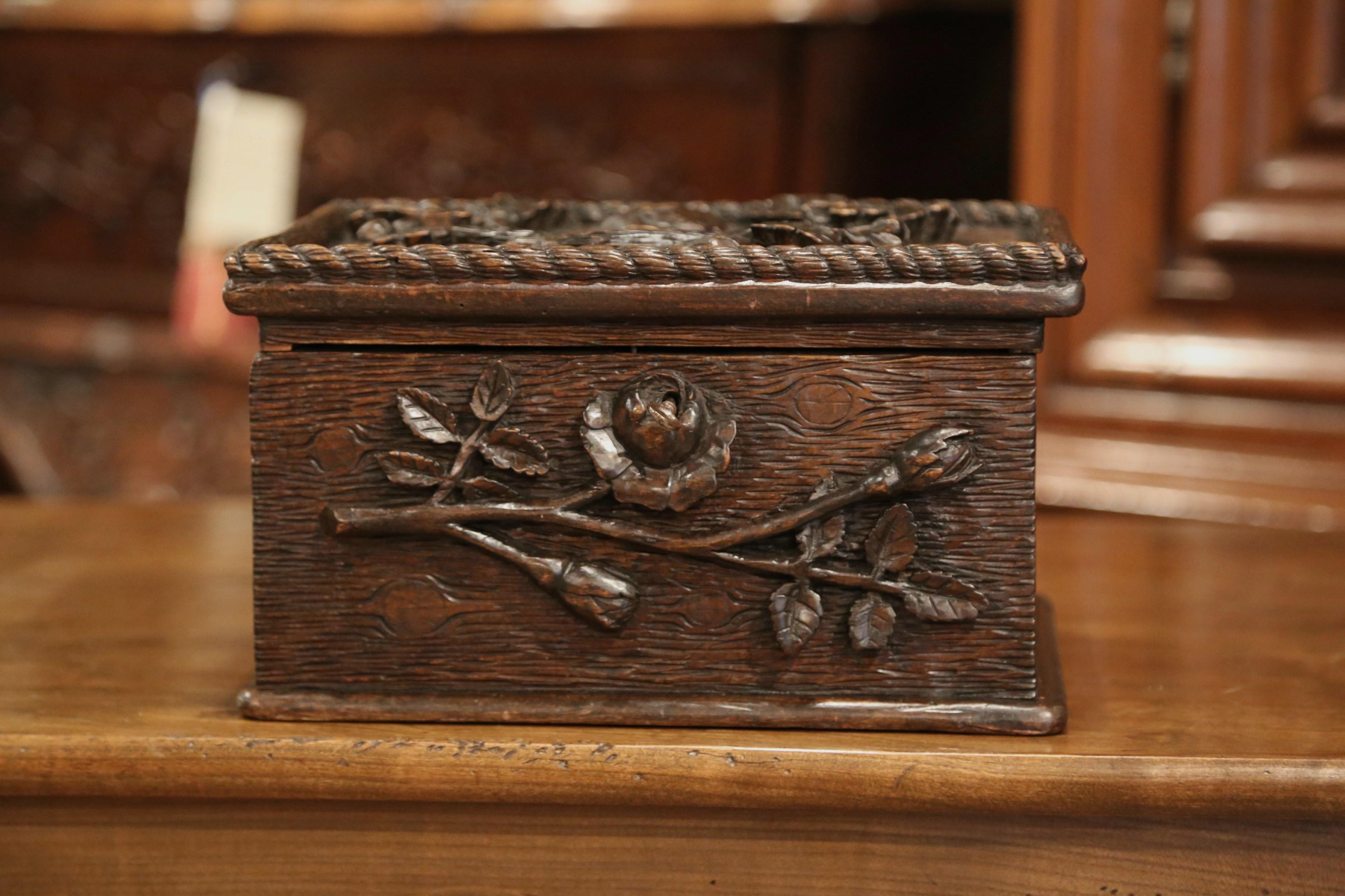 Store your remote controls or other valuables in this rectangular Black Forest letter box. Crafted in France circa 1870, this small, decorative coffer is made of oak and has high relief carvings on the top and front. The top is framed with rope