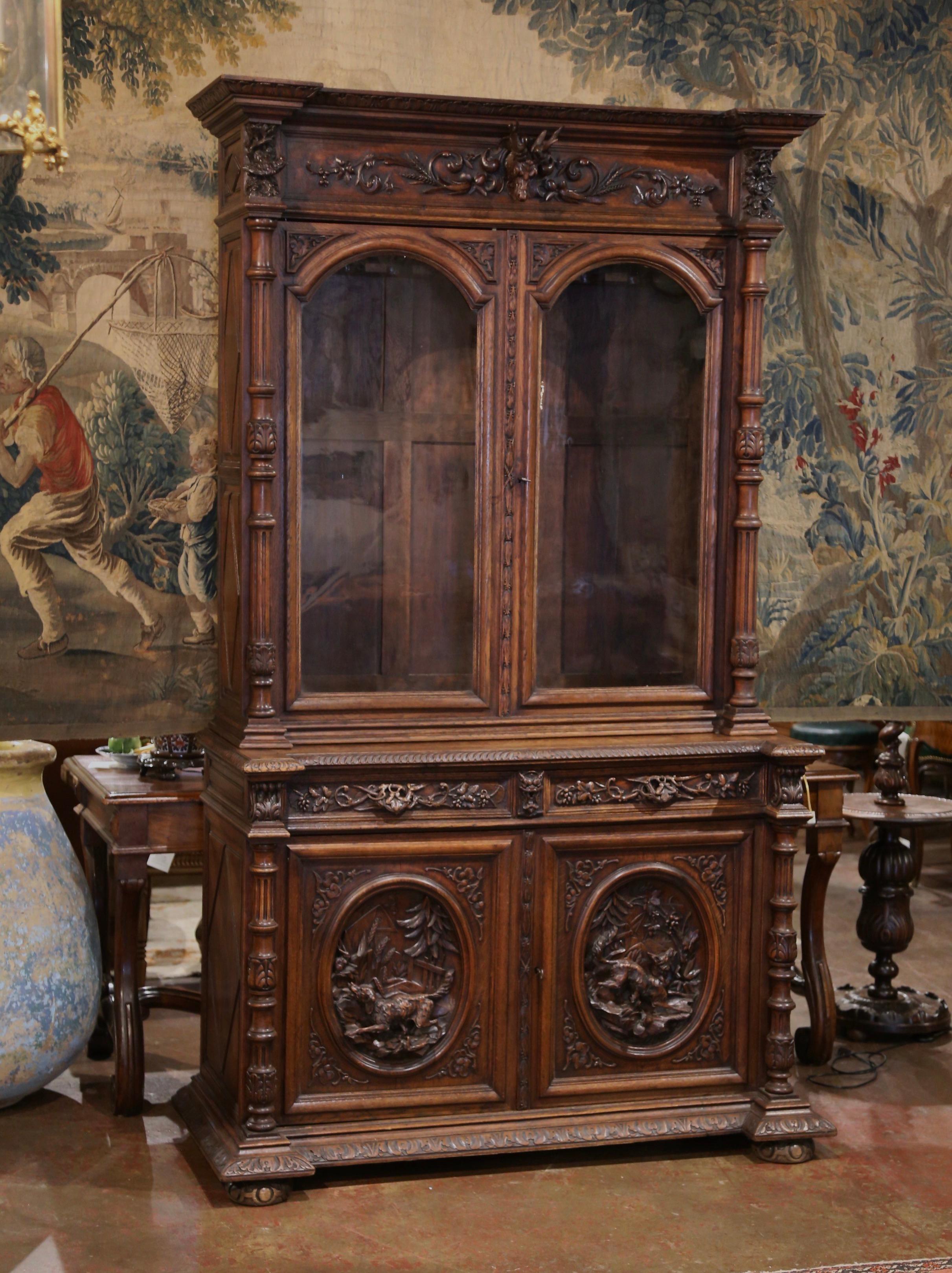 Display your rifle or shotgun collection in this beautifully carved, antique gun cabinet. Created in France, circa 1880, the important two-piece buffet sits on bun feet over a thick bottom plinth with recessed corners. The upper section decorated