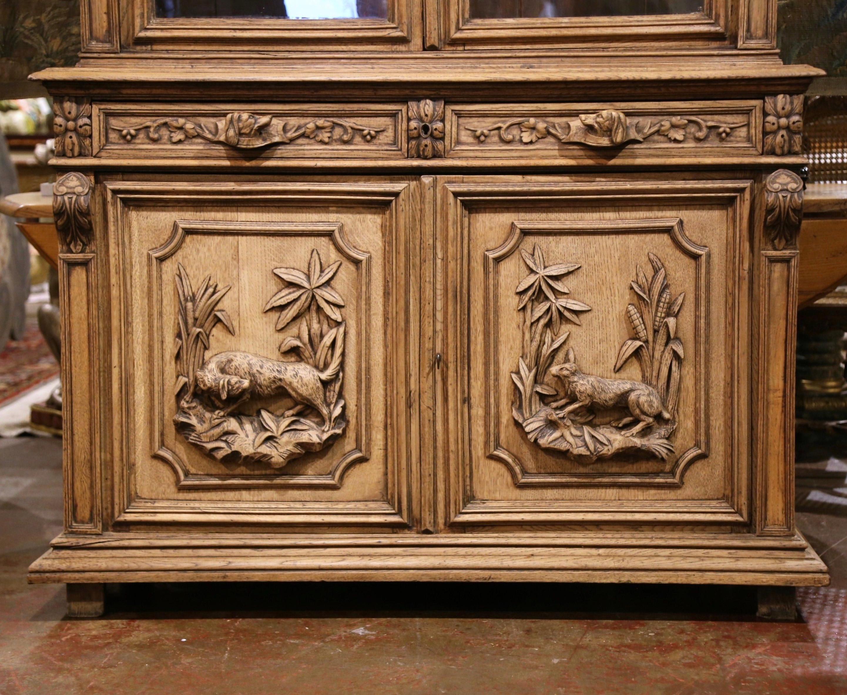 Bleached 19th Century French Black Forest Carved Oak Nine-Gun Cabinet with Hunt Motifs