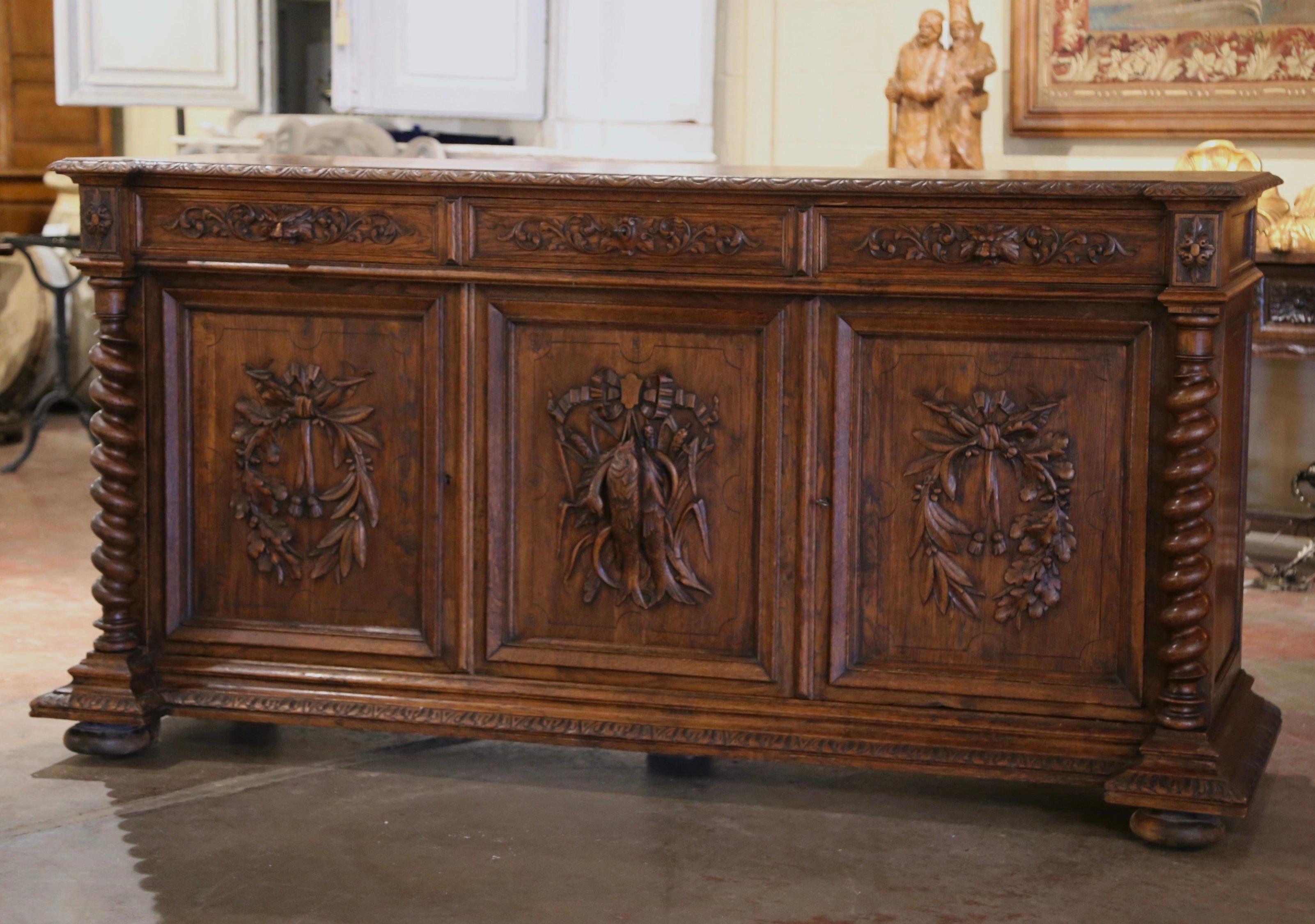Decorate a ranch or hunting lodge with this important antique three-door Black Forest sideboard. Crafted in France, circa 1870, the highly detailed buffet stands on bun feet over a wide bottom plinth with recessed corners. The long cabinet decorated