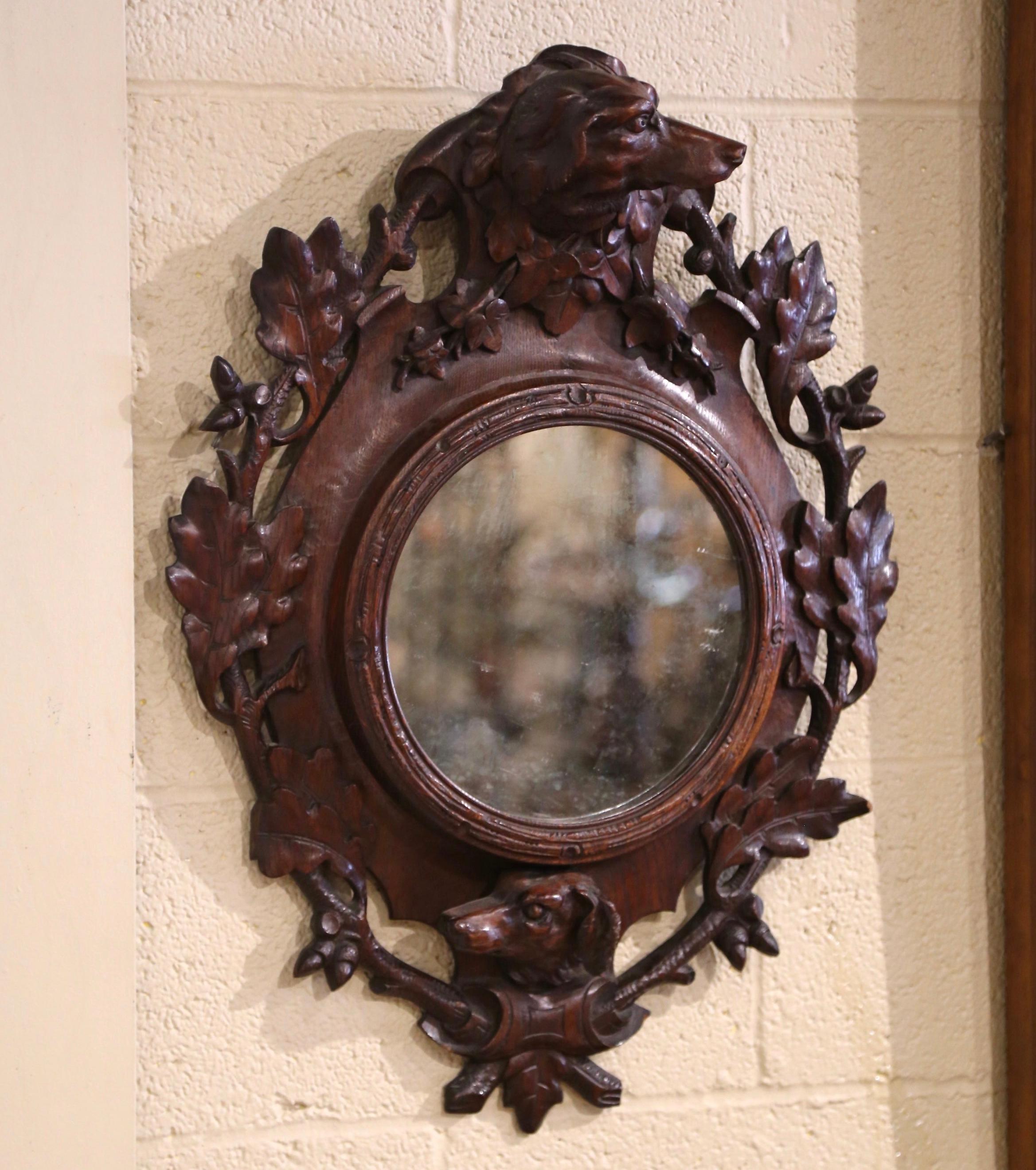 Decorate a powder room, a study or hallway with this heavily carved antique mirror. Created in France circa 1880 and built of oak, the Black Forest frame features carved and pierced acorn and leaf motifs in high relief throughout the frame, and is