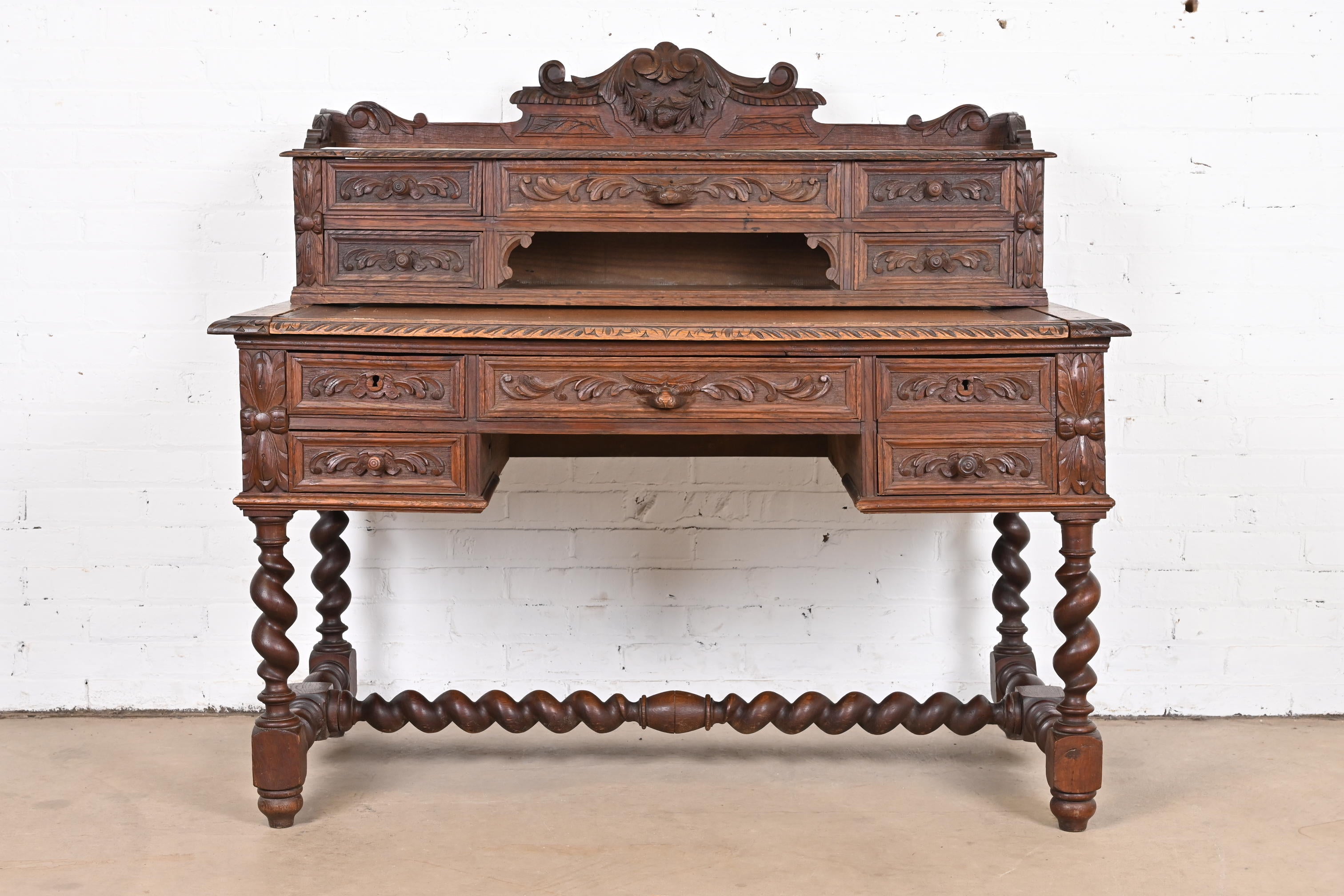 An exceptional antique Henri II or Renaissance Revival ornate carved oak Black Forest writing desk

France, Late 19th Century

Beautiful ornate carved oak, with barley twist legs and stretcher, and slide-out writing surface.

Measures: 51