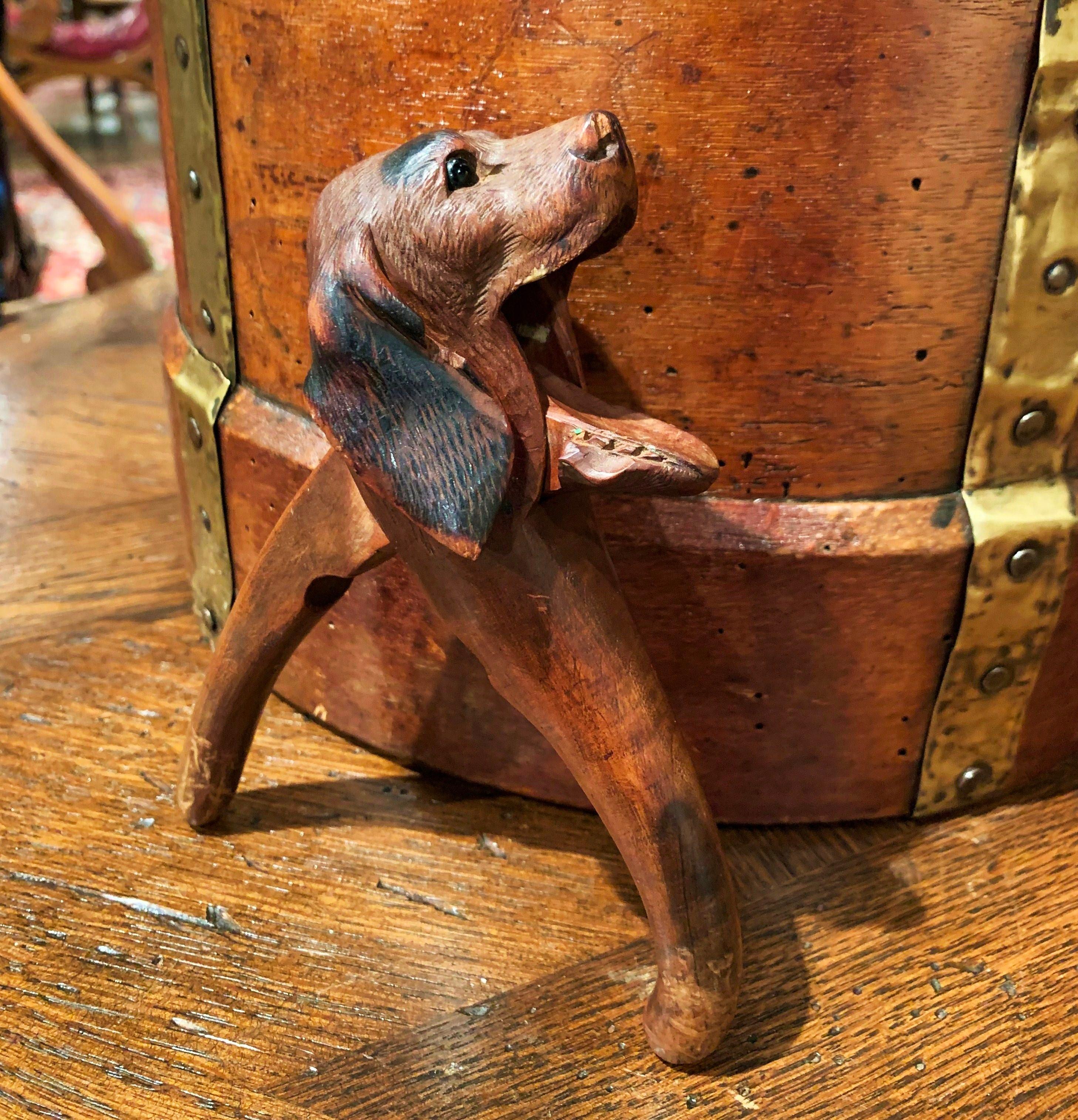 This interesting fruitwood nutcracker was crafted in France, circa 1880, made of walnut, the kitchen utensil features a carved dog head sculpture with horns and embellished with glass eyes. The functional and practical compound lever is in excellent