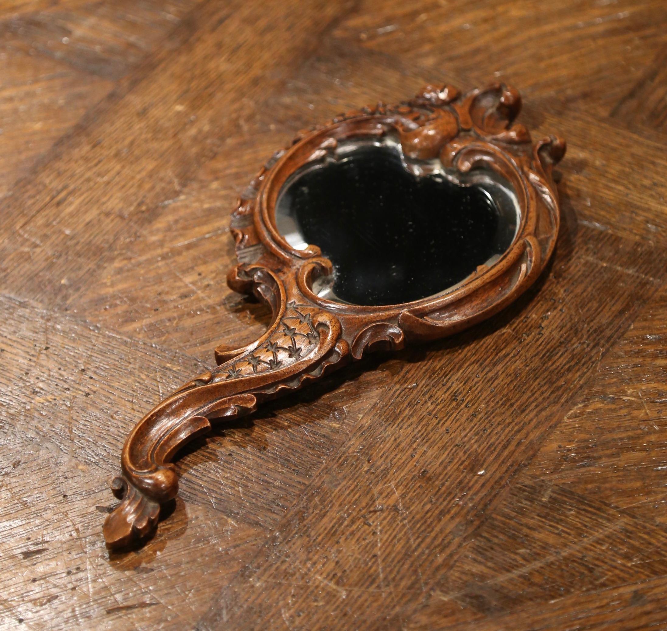Hand-Carved 19th Century French Black Forest Carved Walnut Hand Mirror with Beveled Glass For Sale