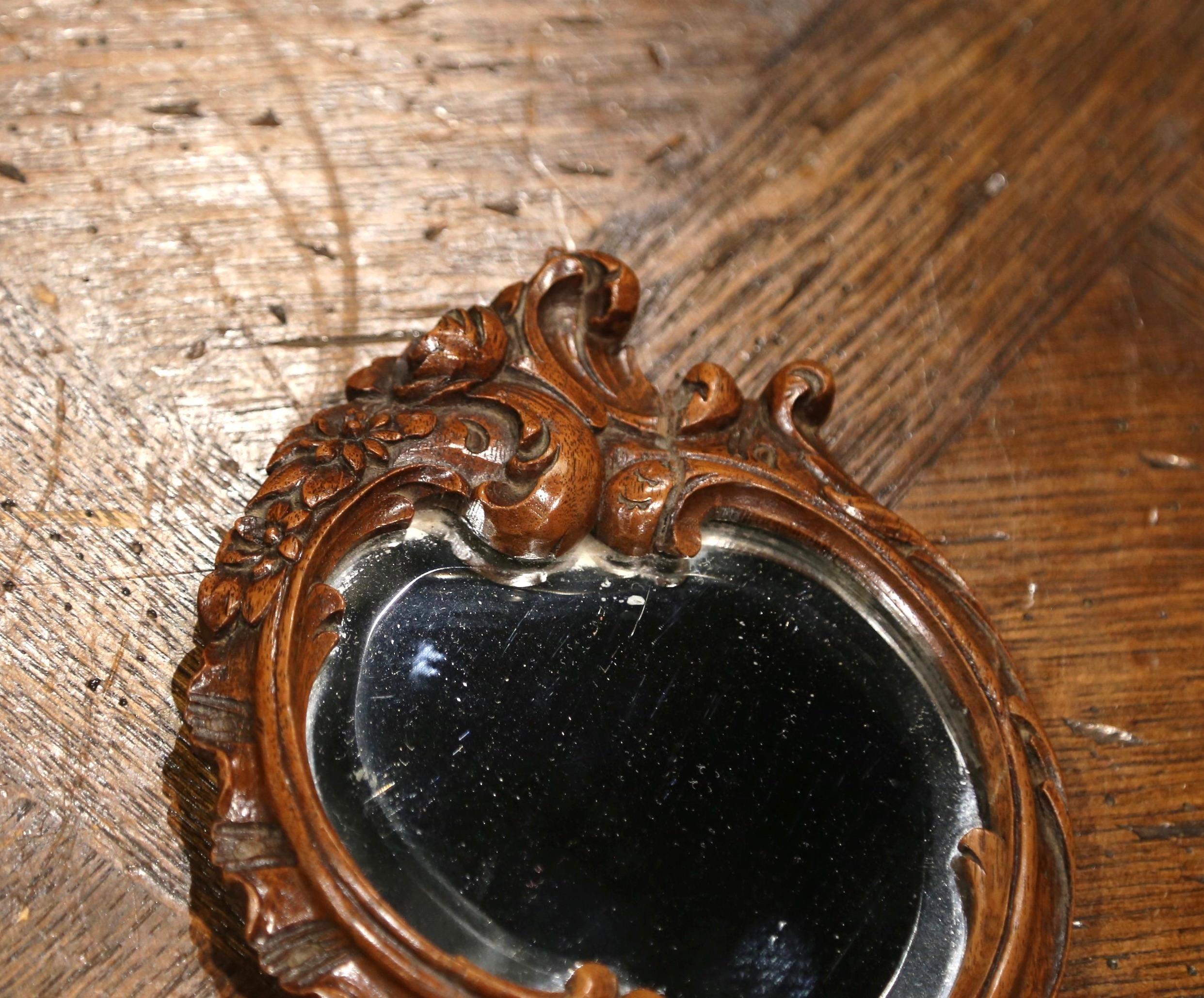 Mercury Glass 19th Century French Black Forest Carved Walnut Hand Mirror with Beveled Glass For Sale