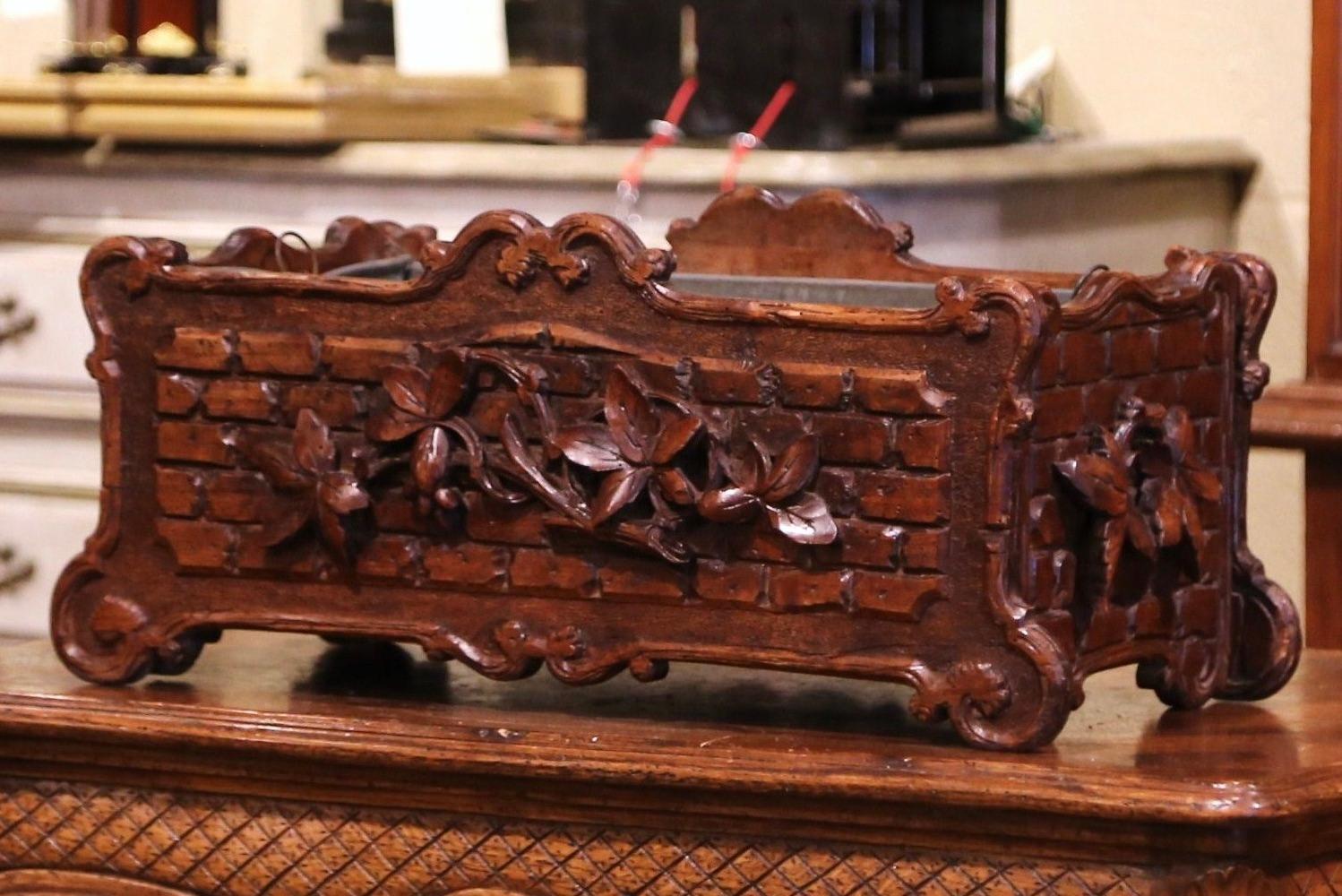 This elegant antique planter was crafted in France, circa 1870. Rectangular in shape with scrolled decor and scalloped edge, the detailed planter is decorated with Fine hand carved floral and leaf motifs on all four sides. The large cachepot with