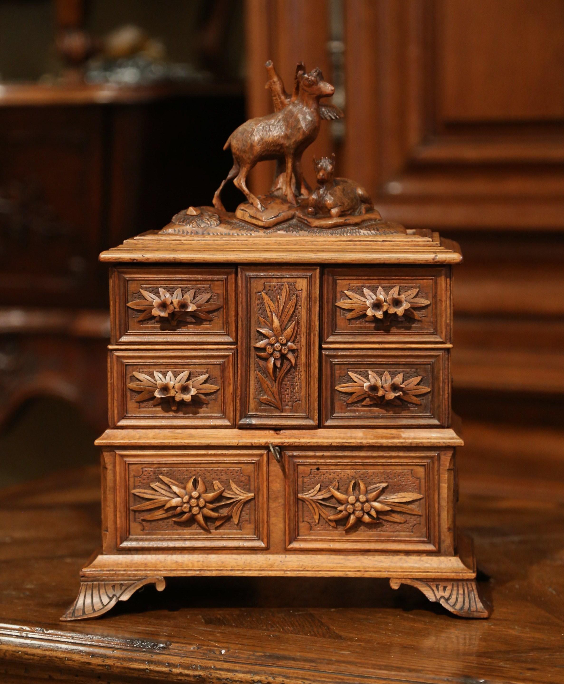 Place your jewelry and small valuable treasures in this beautifully carved decorative box. Created in France, circa 1880, the fruit wood cabinet sits on four feet and features high quality carving decor, including two deer at the pediment