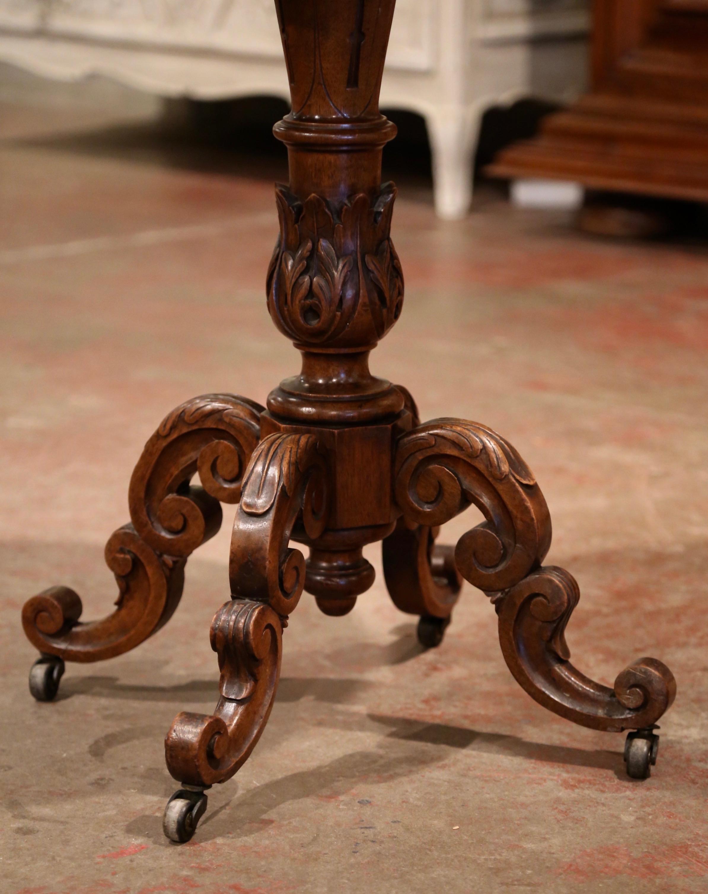 Decorate a wine cellar or a study with this elegant antique fruit wood side table; crafted in France, circa 1870 and round in shape, the occasional table stands on a carved ornate stem decorated with acanthus leaf motifs over four scrolled legs