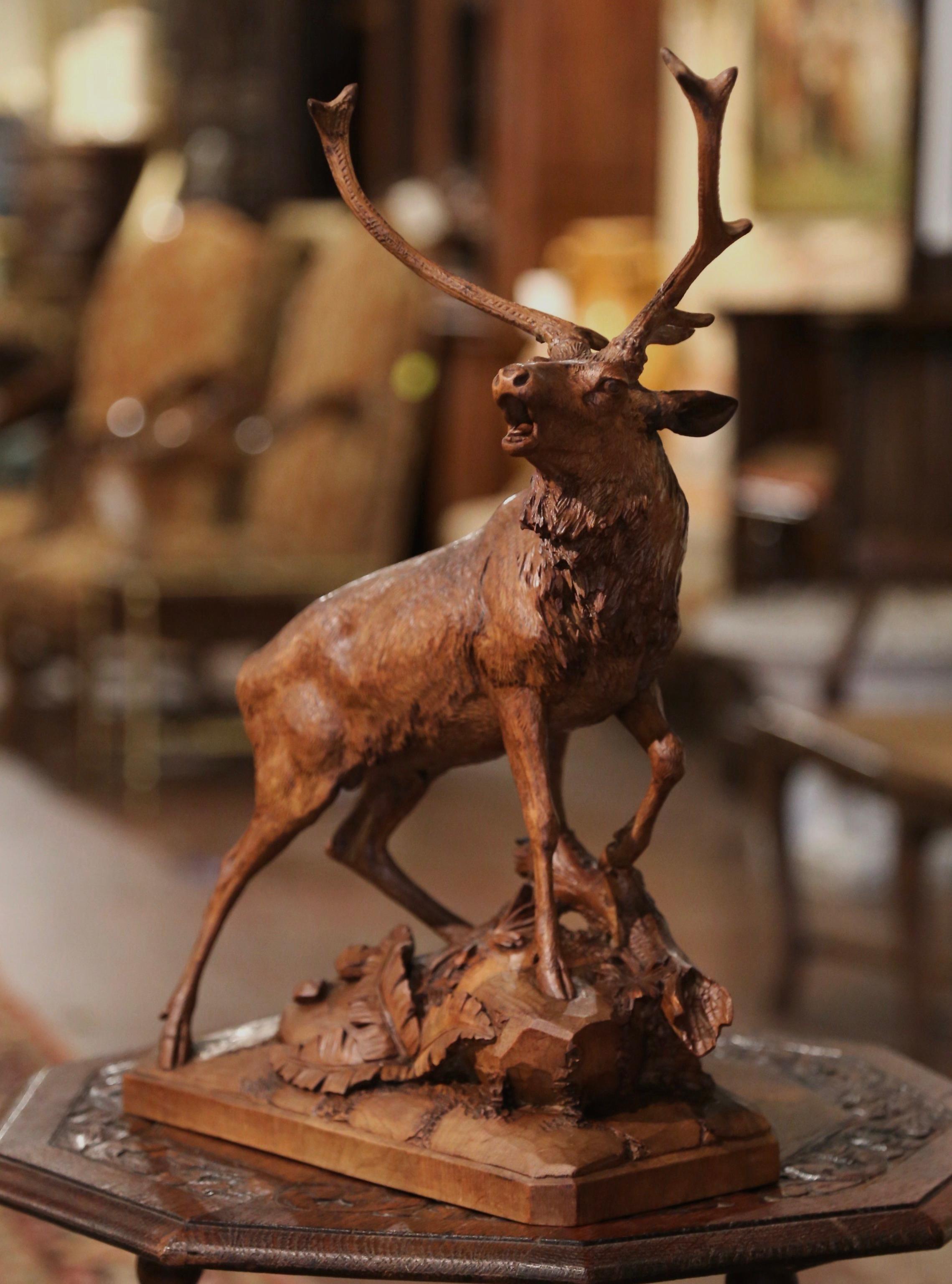 This tall and large antique deer sculpture was created in France, circa 1880. Hand carved in the style of French sculptor Prosper Lecourtier, the detailed walnut piece features a realistic and proud 12 pointer buck roaring at bay while standing on a