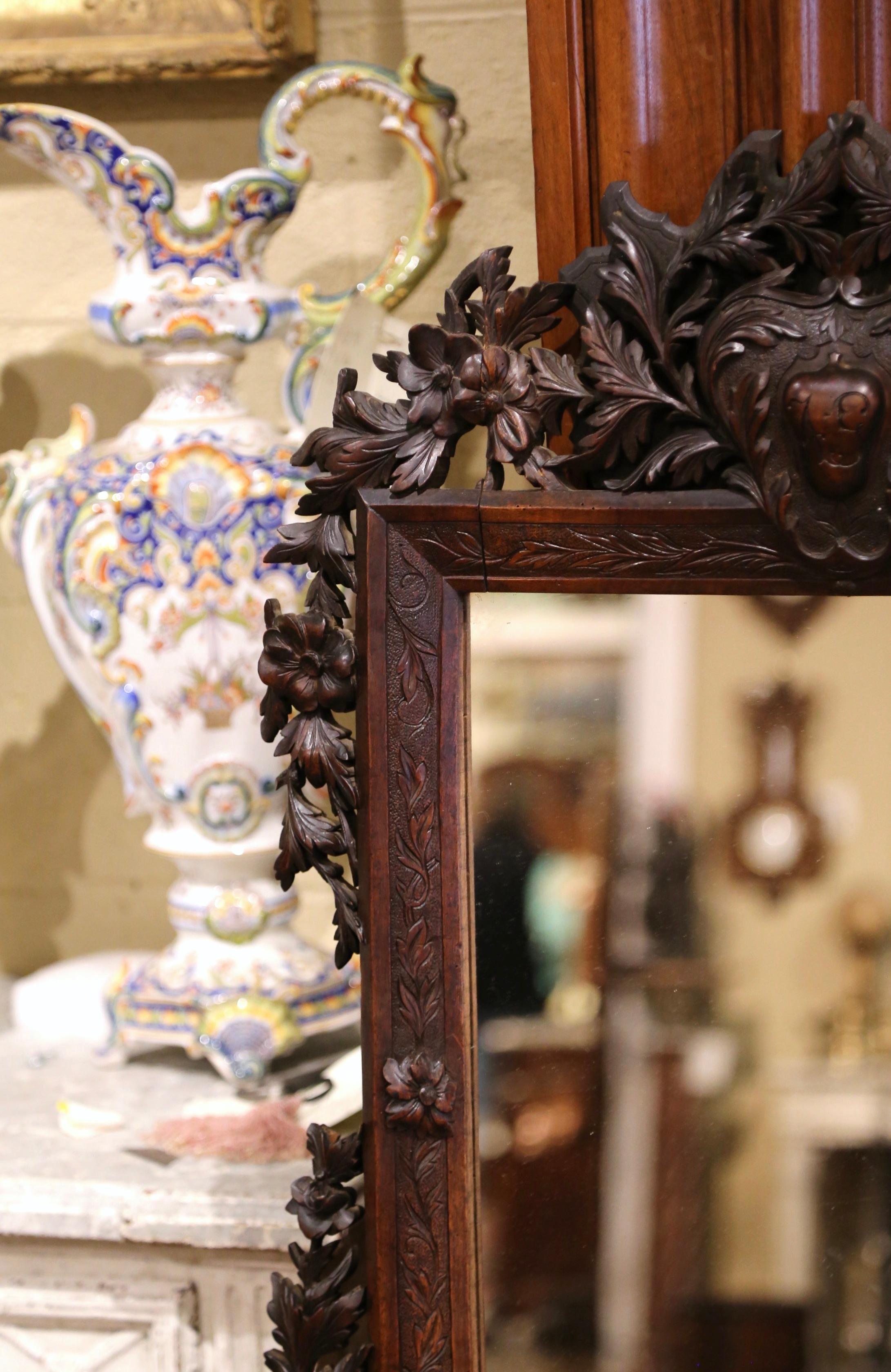 Patinated 19th Century French Black Forest Carved Walnut Wall Mirror with Foliage Motifs