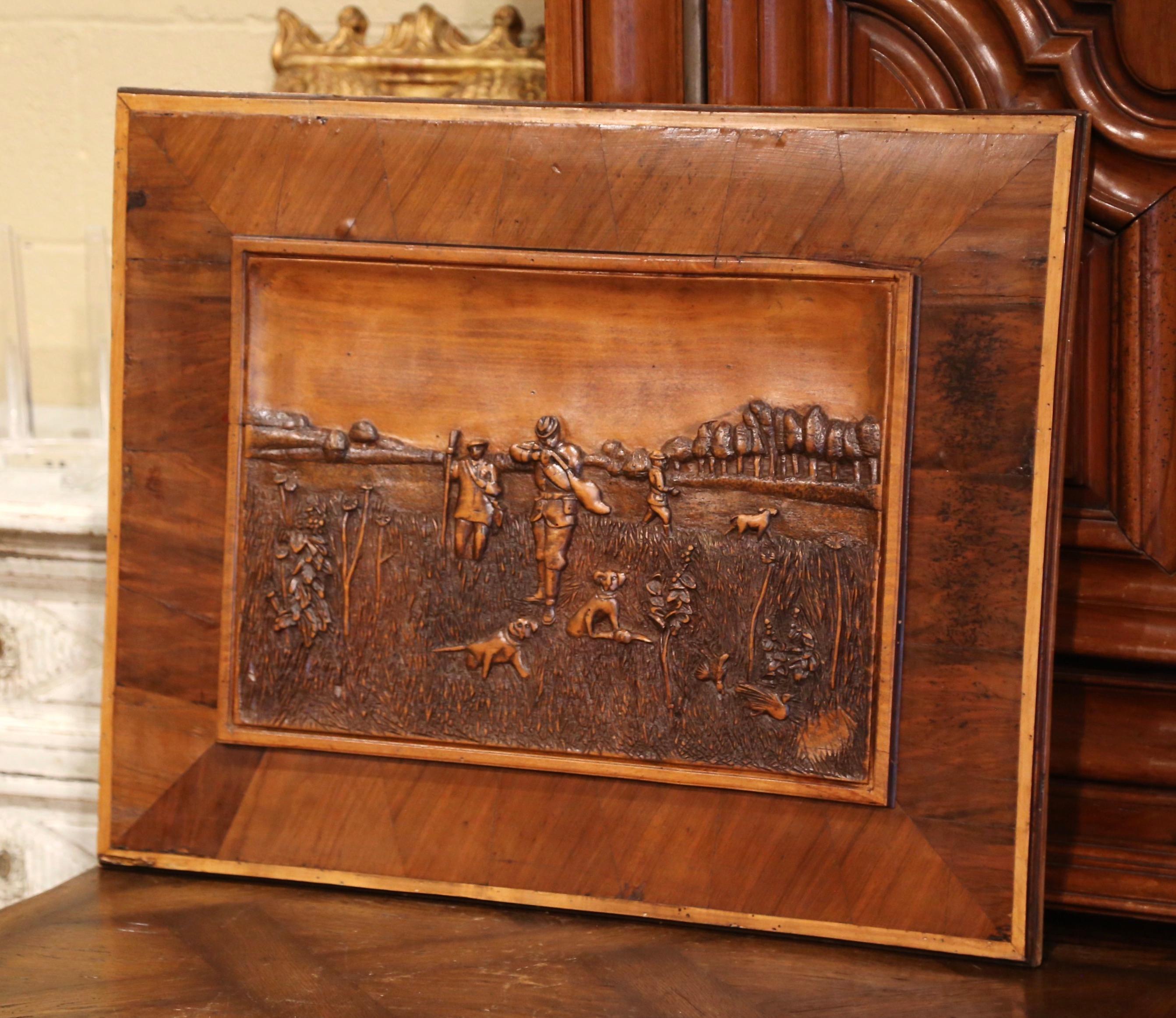 Decorate a ranch, hunting lodge or simply a man's office with this elegant antique wall decor. Crafted in France circa 1870, the hand carved artwork is set in a marquetry frame; it features a hunt scene with hunters in high relief shooting birds and