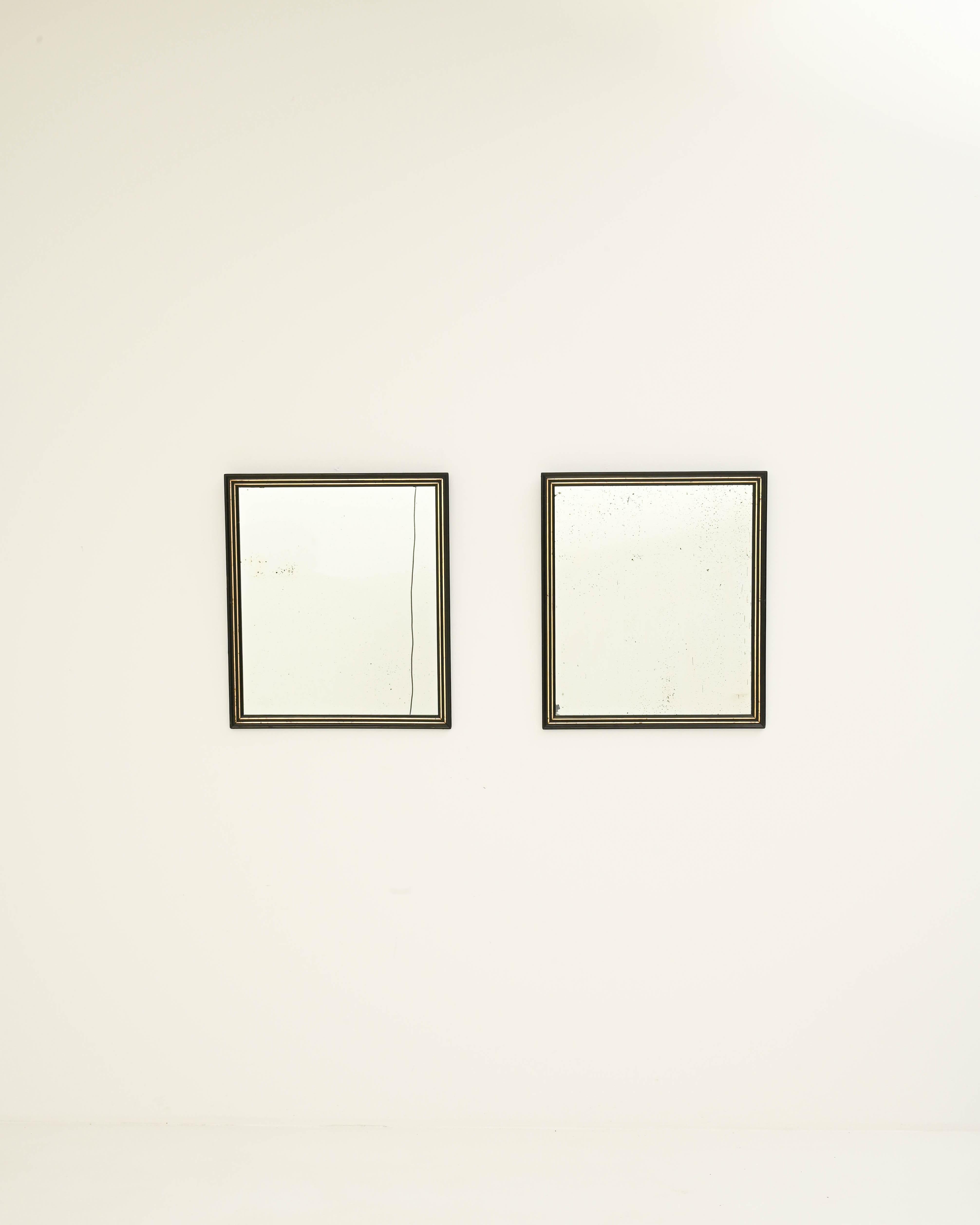 A pair of rectangular wooden framed mirrors, carved with a geometric profile, this functional statement piece imparts a simple elegance. Made in France in the 19th century, the design has distinguished simplicity: a slender contour of gold brings a