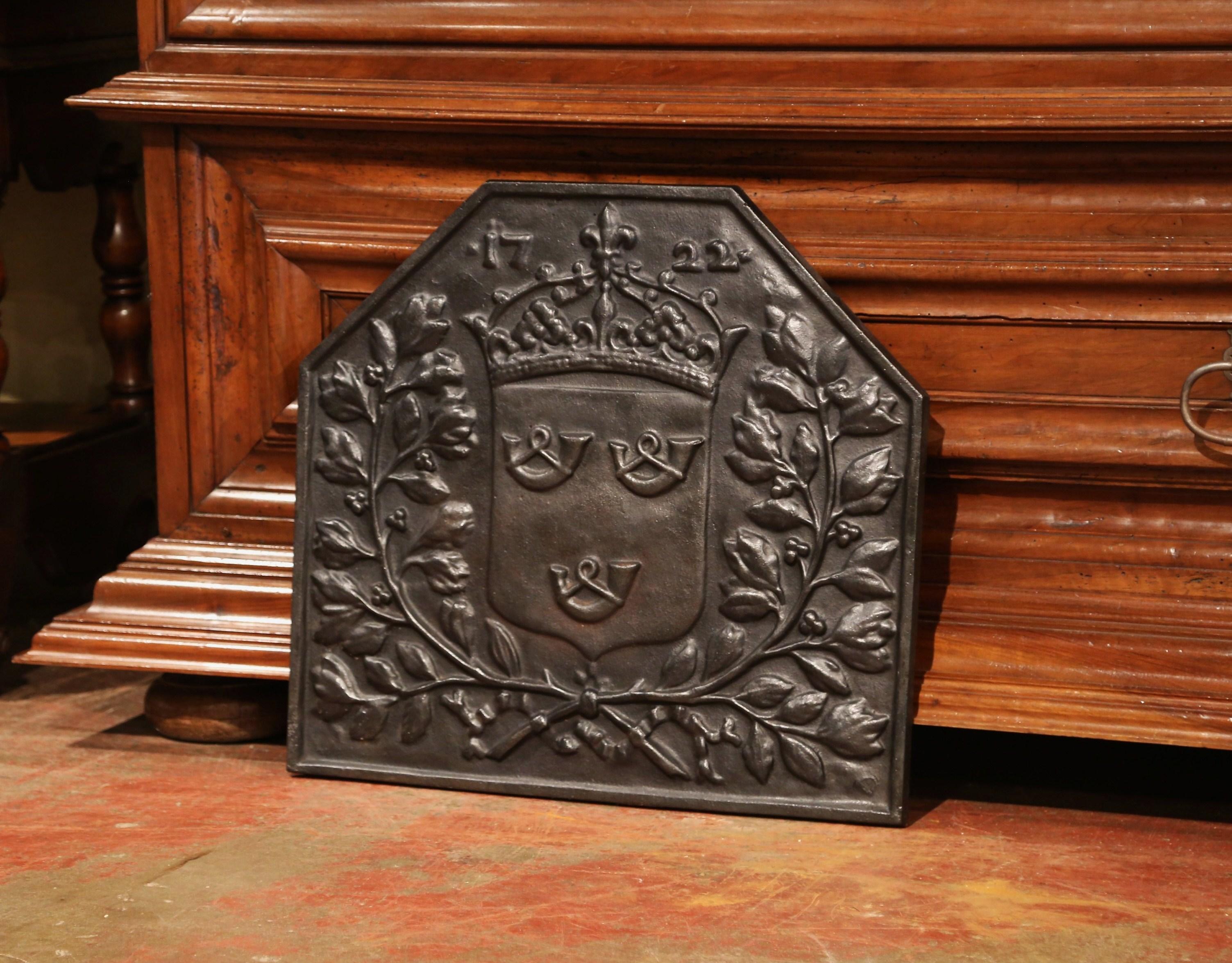 Decorate your fireplace or kitchen back splash with this elegant antique fire back from France, circa 1870. The ornate fireplace essential with a date of 1722 at the top, features a typical French family 