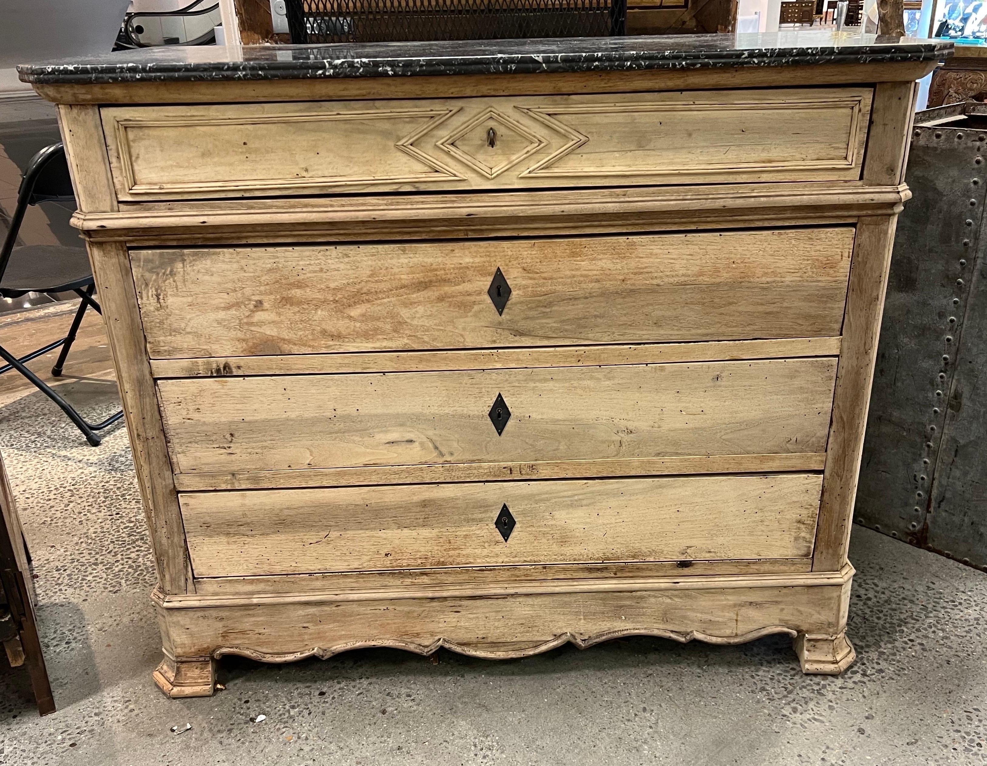 19th century French bleached marble top chest of drawers with diamond shaped molding decoration and diamond shaped eschuteons. The original dark marble top contrasts well with the light color bleached walnut.