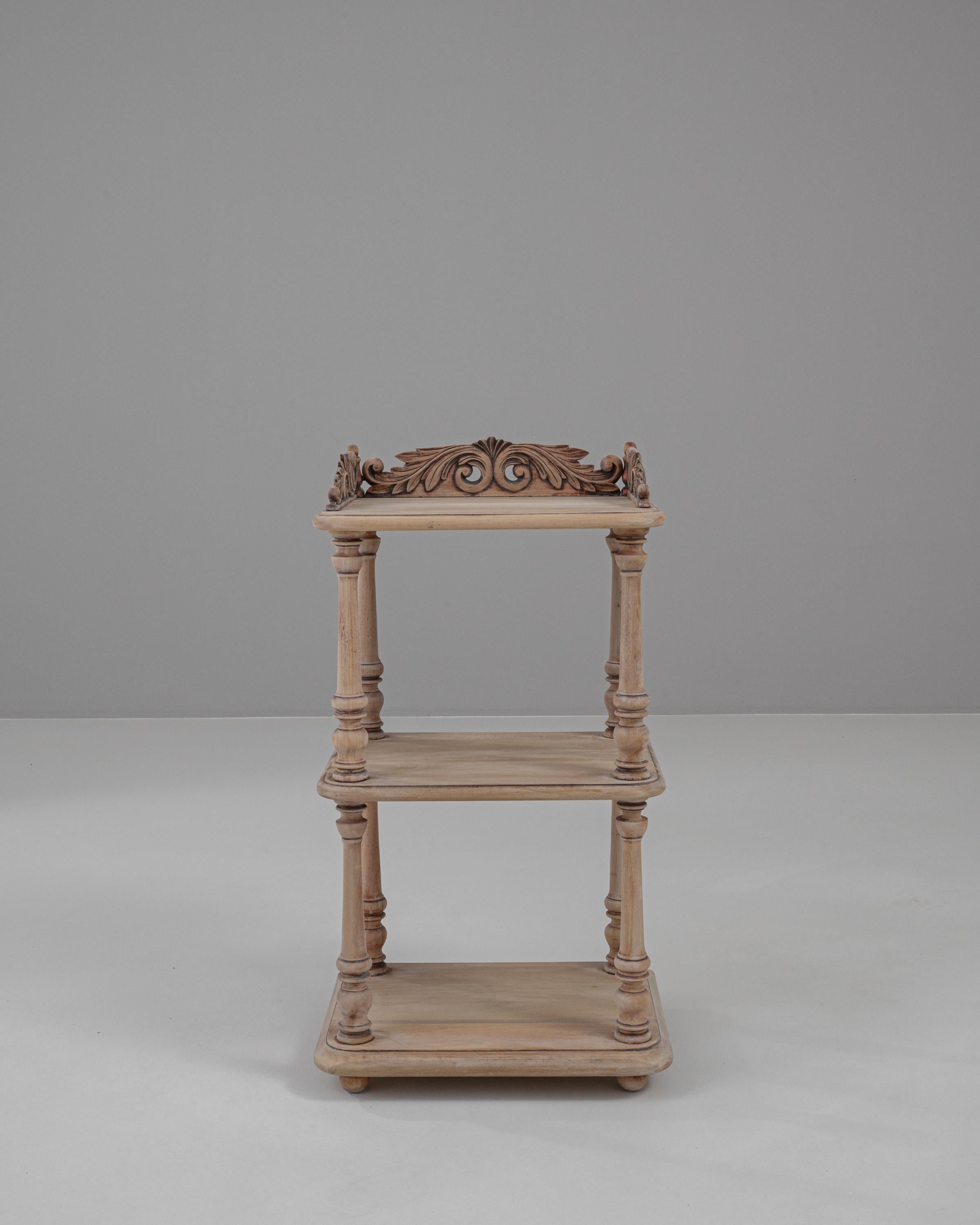Add an element of refined grace to your bedroom with this 19th Century French bedside table, beautifully crafted from bleached oak. This elegant piece features ornate carvings along the top rail, showcasing exquisite floral motifs that are testament