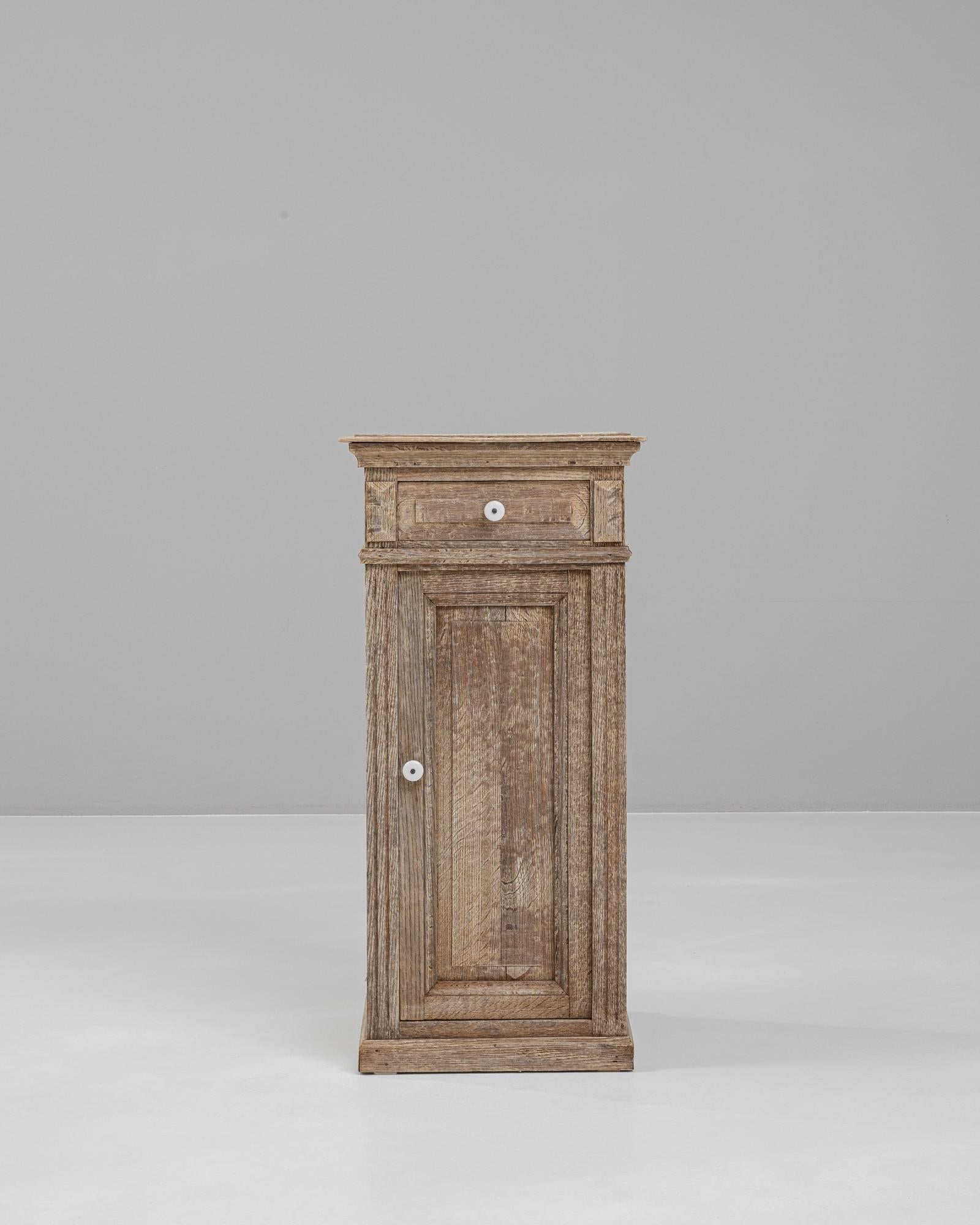 Introduce a piece of history into your bedroom with this 19th Century French Bleached Oak Bedside Table. This authentic antique is crafted from solid oak, offering exceptional durability and a timeless appeal. The wood has been expertly bleached to