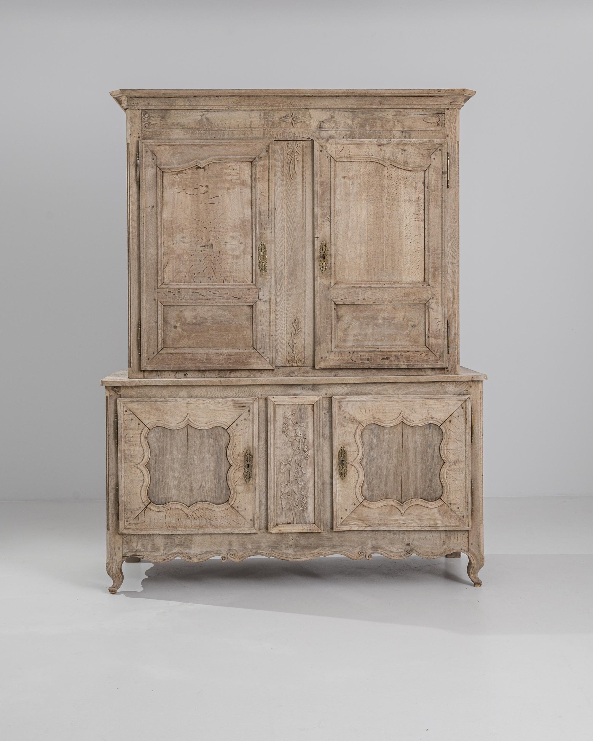 The quintessential French Provincial buffet cabinet, made circa 1800. The simple geometric shape recalls a countryside local and the time tested approach of regional French cabinet makers. A two door base seats a tall upper cabinet, composed with