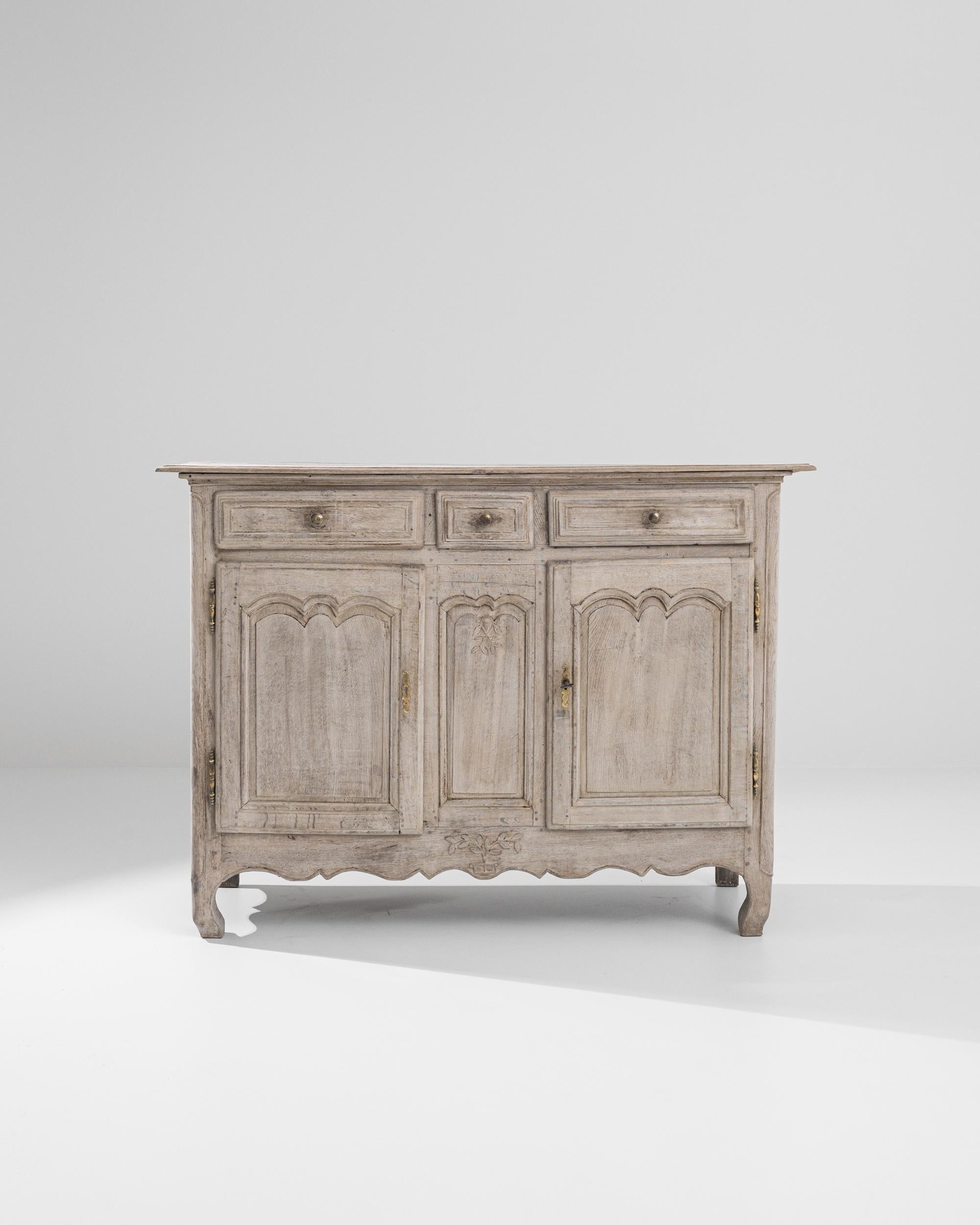 The quintessential Country French buffet cabinet, made circa 1800. The simple geometric shape recalls a countryside local and the time tested approach of regional French cabinet makers. Combining earthy colors and elevated craftsmanship, this buffet