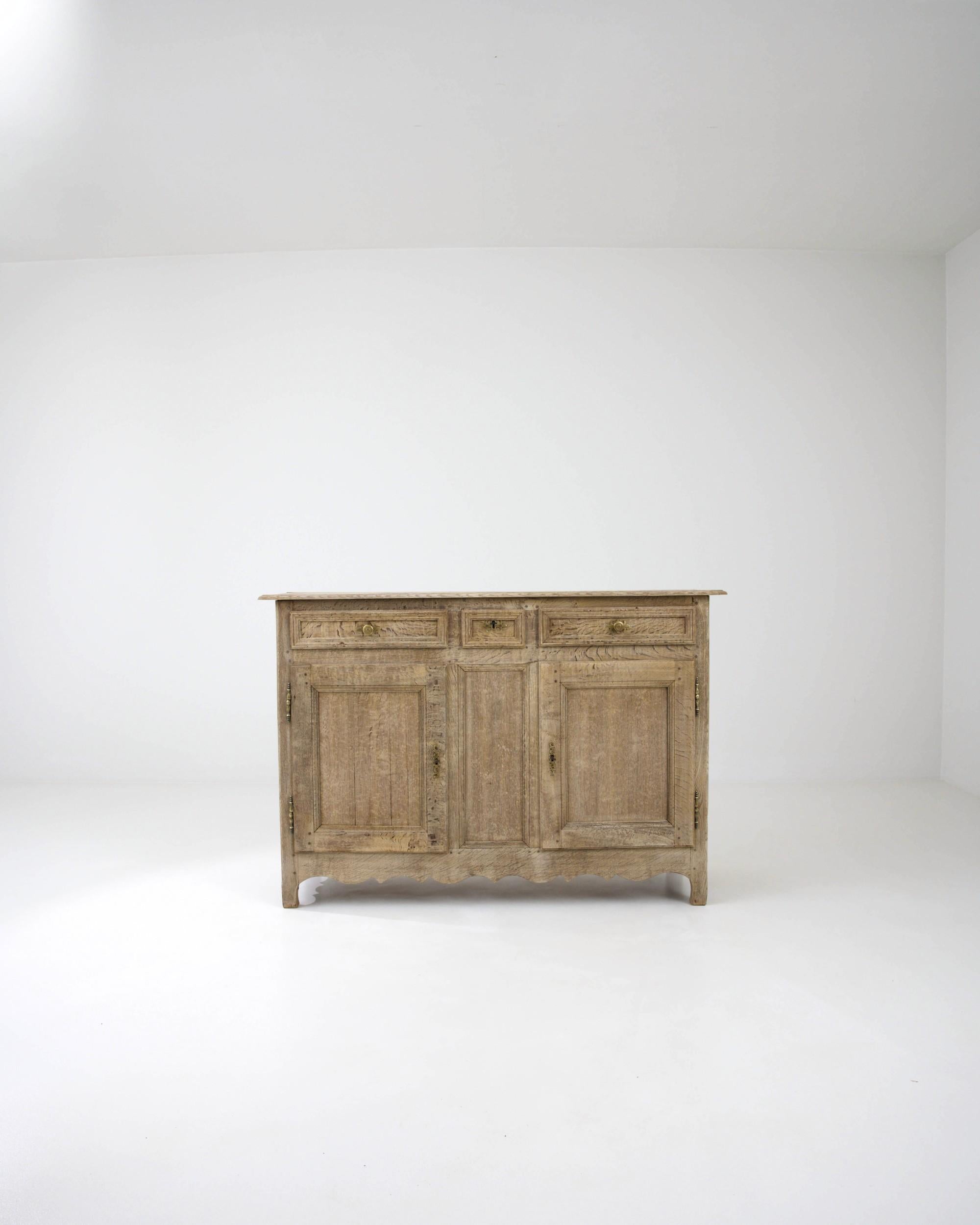 A quintessential Country French buffet cabinet, made circa 1800. The simple geometric shape recalls a countryside local and the time tested approach of regional French cabinet makers. Combining earthy colors and elevated craftsmanship, this buffet
