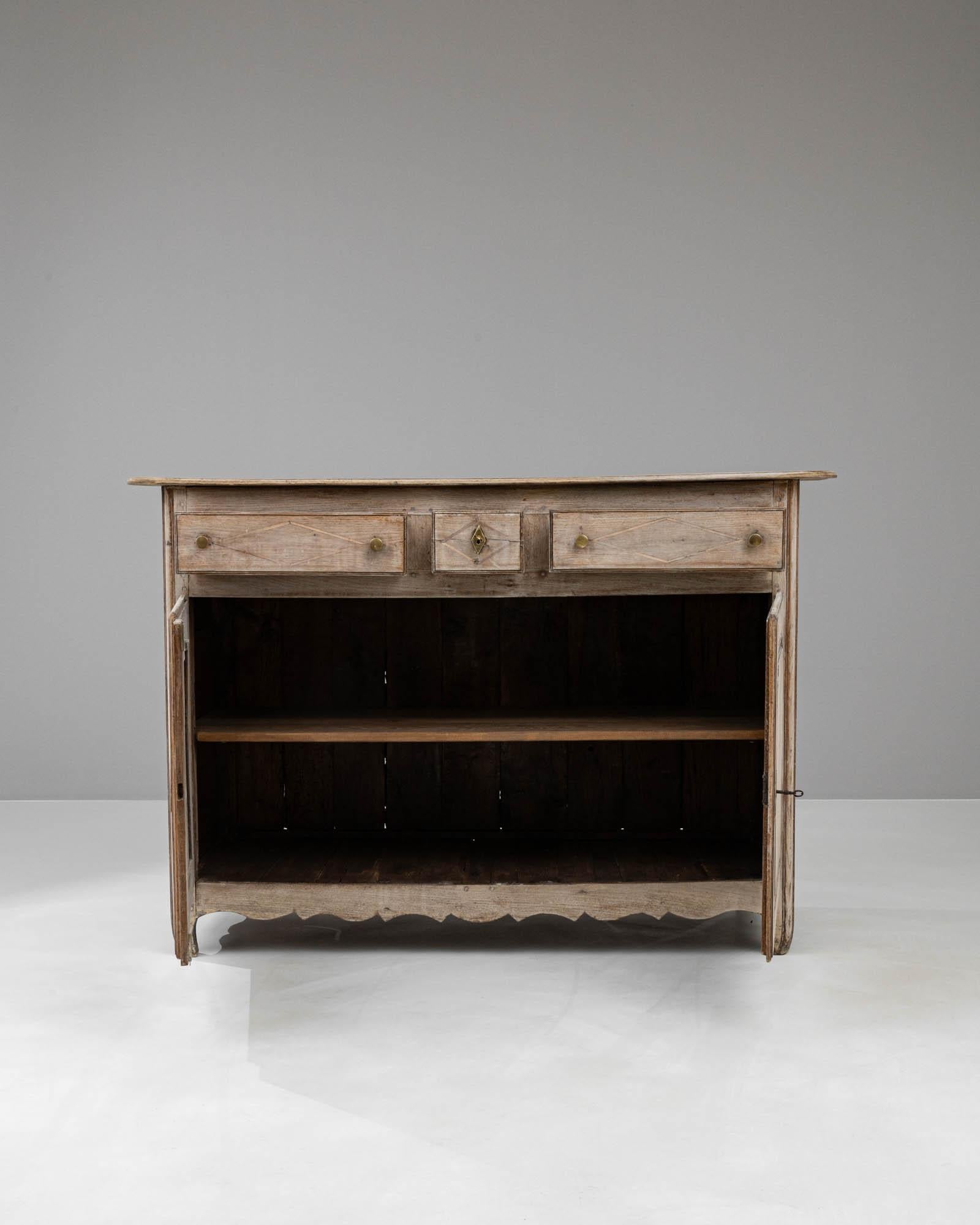 Transport yourself to the rustic French countryside with our 19th Century French Bleached Oak Buffet. This majestic piece brings the allure of vintage Provence into your home with its softly weathered bleached oak finish, infusing a touch of antique